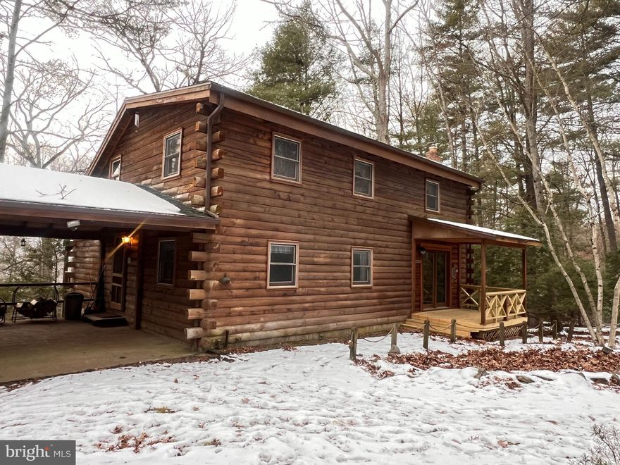 This cozy 2 BR 2BA (with main floor bonus room) is a must see! Adorable but expansive cabin in Sleepy Creek Orchard has amazingly serene views and peaceful surroundings. The home invites a new owner to enjoy a comfortable open concept feel, multiple covered porches, two wood stoves (an Elmira and a Hearthstone) and  vaulted ceilings with skylights. Winter offers a fantastic view of Sleepy Creek. A staircase leads down to a small deck for an even better view of the water. The 3+ acreage stretches to the other side of the creek allowing for extra hiking and adventure in the warmer months. The home has 1 large master bedroom and 1 small bedrooms with nicely sized closets on the 2nd floor and a third bonus room on main floor with no closet could you be used as an additional bedroom. The kitchen boasts updated granite countertops and an aged bronze faucet.  A full sized unfinished walkout basement is ready for expansion or to continue storing your kayaks and other equipment!  
Tuscarora Trail (the Blue Dot trail) is great for hiking and biking trails.  Sleepy Creek Orchard Subdivision at Steamboat Landing allows for private access to Sleepy Creek River for kayaking. The town of Berkeley Springs is less than 15 minutes away with shopping, restaurants and grocery store available. Cacapon State Park is about 40 minute drive where you can enjoy dog friendly hiking and even a beer garden! Washington DC and NOVA only approx 1.5 hours. Come get away from it all and enjoy peace and quiet with gorgeous views!