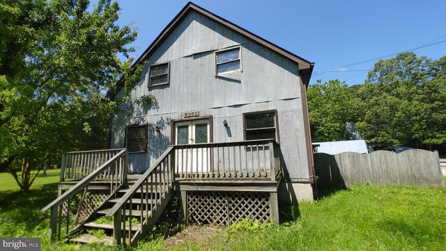 Don't miss this wonderful opportunity to own this porch front home seated in an expansive private  lot approximately 3.38 acres. Home features hardwood floors that flows from the combined living and dining rooms to the nice sized kitchen with appliances and main level bedroom and bath. There is a full bath on each level and three more bedrooms on the upper level. The sunroom with wide windows and lots of natural light has a great view of the backyard and leads to the rear deck, which is a perfect spot for outdoor fun.  The rear exterior includes a 3-car detached garage with large workshop and an unfinished upper level. Home is located in a water-oriented community and is conveniently close to the beach, marina and Shady Side attractions. NOTE - Buyers winning the Highest & Best must understand that they participated in a Highest & Best, Multiple Offers Situation and that any requests to the Seller for Special Concessions, Repairs or Switch in Financing could result in the Seller terminating and retaining Buyer's EMD.