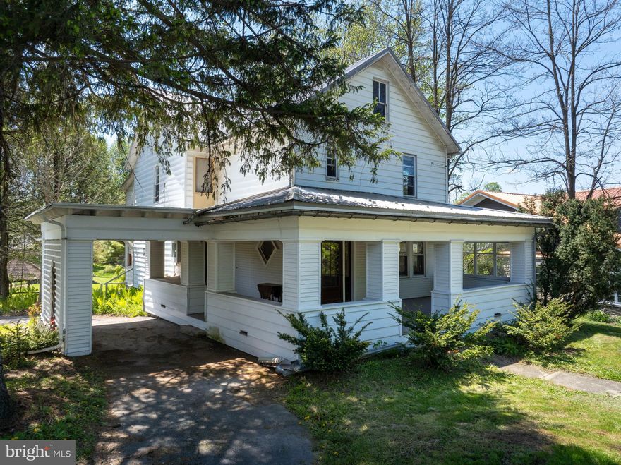Looking for a 3-bed home in Millheim with historic character, flexible space, and a Main Street location? This 1920 home at 147 E Main Street blends classic charm with practical updates, including mostly updated windows, a newer metal roof, inviting outdoor areas, and lower-level potential for work, storage, hobbies, or creative use. Set on a 0.28-acre lot with mature trees, this home welcomes you with a grand covered porch, classic white exterior, and timeless curb appeal. Inside, you’ll find warm hardwood floors, ceramic tile, chestnut wood trim, wide room openings, original-style doors, a detailed staircase, and large windows that bring natural light into the main living spaces. The open floor plan creates comfortable flow through the home, while the kitchen offers a cheerful breakfast nook, checkerboard flooring, stainless appliance, double sink, and practical workspace. This 3-bed home in Millheim also includes 2.5 baths, an attic with generous storage, and a lower level with flexible possibilities for storage, hobbies, workspace, or in-home business use, subject to local requirements. Outside, enjoy the shade of mature trees, the covered porch, side covered parking area, and a detached garage that may also serve as a workshop. Photo-visible character details include the glass entry door with sidelights, diamond accent window, wood staircase, substantial trim, and spacious rooms with classic 1920 appeal. 147 E Main Street offers character, function, storage, and opportunity in one memorable Millheim property. Schedule your showing to see the porch, floor plan, garage, lower level, and charm in person. 
*Various home scenes were virtually staged or created.*