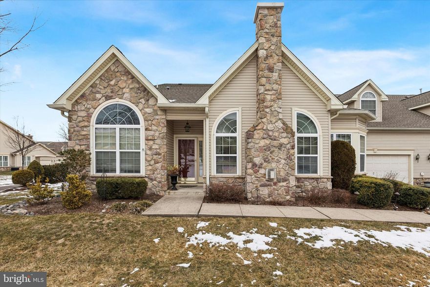 Welcome to 209 Fairway Drive, a beautifully maintained Willow model in the highly sought-after Villas at Five Ponds, a premier active adult community known for its vibrant lifestyle and exceptional amenities. Offering three bedrooms and three full baths, this thoughtfully designed home blends everyday comfort with inviting spaces for entertaining.  A charming stone-accented façade creates warm curb appeal and a welcoming first impression. Inside, the foyer features soaring ceilings and abundant natural light. The open-concept main living area includes a spacious living room centered around a cozy gas fireplace, flanked by Palladian-style windows and enhanced by abundant recessed lighting. This space flows seamlessly into the dining area, making it ideal for both gatherings and quiet evenings at home.
At the heart of the home is a well-appointed chef’s kitchen featuring upgraded 42-inch cabinetry, granite countertops, tile backsplash, stainless steel appliances, and generous prep space. Its open layout keeps the kitchen connected to the main living areas, allowing conversation and activity to flow naturally.
Designed for convenient single-floor living, the main level features a spacious primary suite with a tray ceiling, sunlit bay window,  sitting area, and two walk-in closets. The private ensuite bath includes a double vanity, soaking tub, and separate walk-in shower. A second bedroom and full hall bath provide comfortable accommodations for guests. French doors open to a flexible den or office with direct patio access—perfect for working from home, hobbies, or enjoying morning coffee. A main-level laundry room connects to the oversized two-car garage, complete with inside access, opener, exterior keypad, and a spacious storage closet. Upstairs, a freshly painted loft with a full bath and bonus area offers exceptional versatility, ideal as a third bedroom, guest suite, office, or private retreat.
Residents enjoy an amenity-rich lifestyle with a clubhouse, fitness center, indoor and outdoor pools, tennis courts, walking paths, and a full calendar of social activities. Move-in ready and thoughtfully designed, 209 Fairway Drive offers comfort, flexibility, and community in one exceptional home.