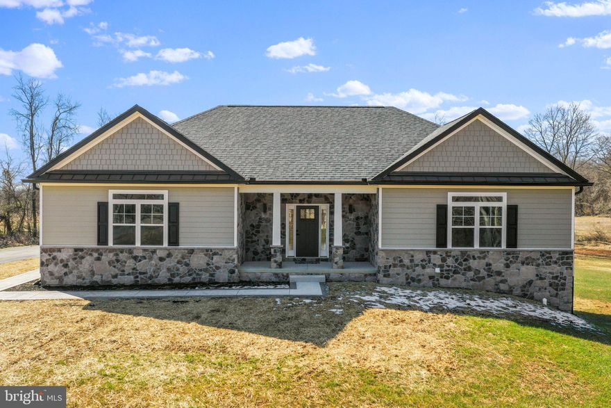 Brand new CUSTOM BUILT home on over 2 acres!  Construction is complete and ready for a new buyer. This house is full of luxury finishes.  The kitchen has been upgraded with recessed lights, granite counters, stainless steel appliances and custom cabinets.  The great room is a nice large open space connecting to the kitchen for ease of entertaining.  The great room welcomes you with cathedral ceilings , gorgeous hardwood floors , a stone fireplace and views to the rear farmland and stunning sunsets.  The primary bedroom has a tray ceiling, a full private bath with a deep soak tub and separate tiled shower and two individual closets.  Bedroom 2 and 3 are divided by a full bath and are positioned on the opposite side of the house for privacy.   The main level laundry room offers convenience.
The lower level has been partially finished with a flex room, 4th bedroom and a full bath.  Walk right out to the amazing yard from the basement.  Play some catch, build a playset or grow the most amazing garden.  
The other 3/4 of the basement is unfinished and is awaiting your dreams and desires.   Hardiplank siding wraps the house with a taste of elegance and warmth while the stone front foundation and extra transom windows give  this home the custom feel of perfection.