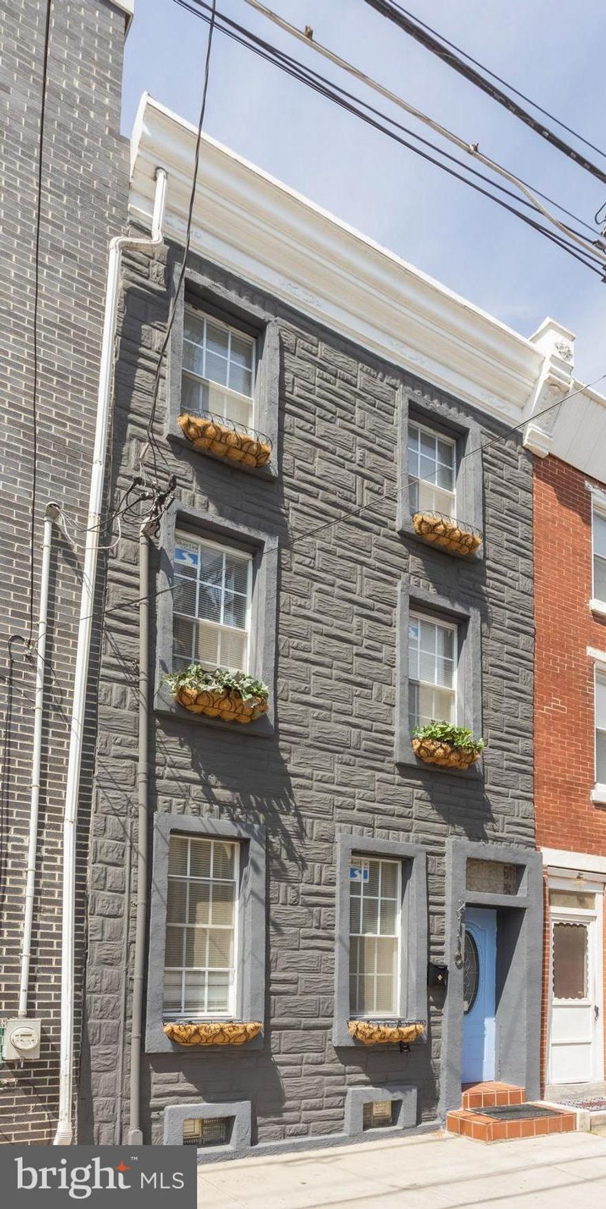 Welcome to this newly renovated three story interior row home located in East Kensington. You will notice the striking charcoal exterior with beautiful window boxes.  As you enter the front door, you see  the new laminate flooring throughout the first level. As you pass through the comfortable living & dining rooms, you enter the newly remodeled kitchen with gray shaker cabinets, white quartz countertops, mosaic tile backsplash and stainless steel appliances. Glass sliding doors lead to a fenced in patio. A powder room finishes off the first level.
As you go up the stairs to the second level, you see the black modern wrought iron railing. The second level has two bedrooms each with laminate flooring and freshly painted and a modern bathroom complete this level. Continue up the stairs to the third level which has two more bedrooms, with one leading to the rooftop deck with new railing and flooring.
As you go down the lower level there is gray laminate flooring with a half bath, laundry room and entertainment space. There is also a utility room and closet space.