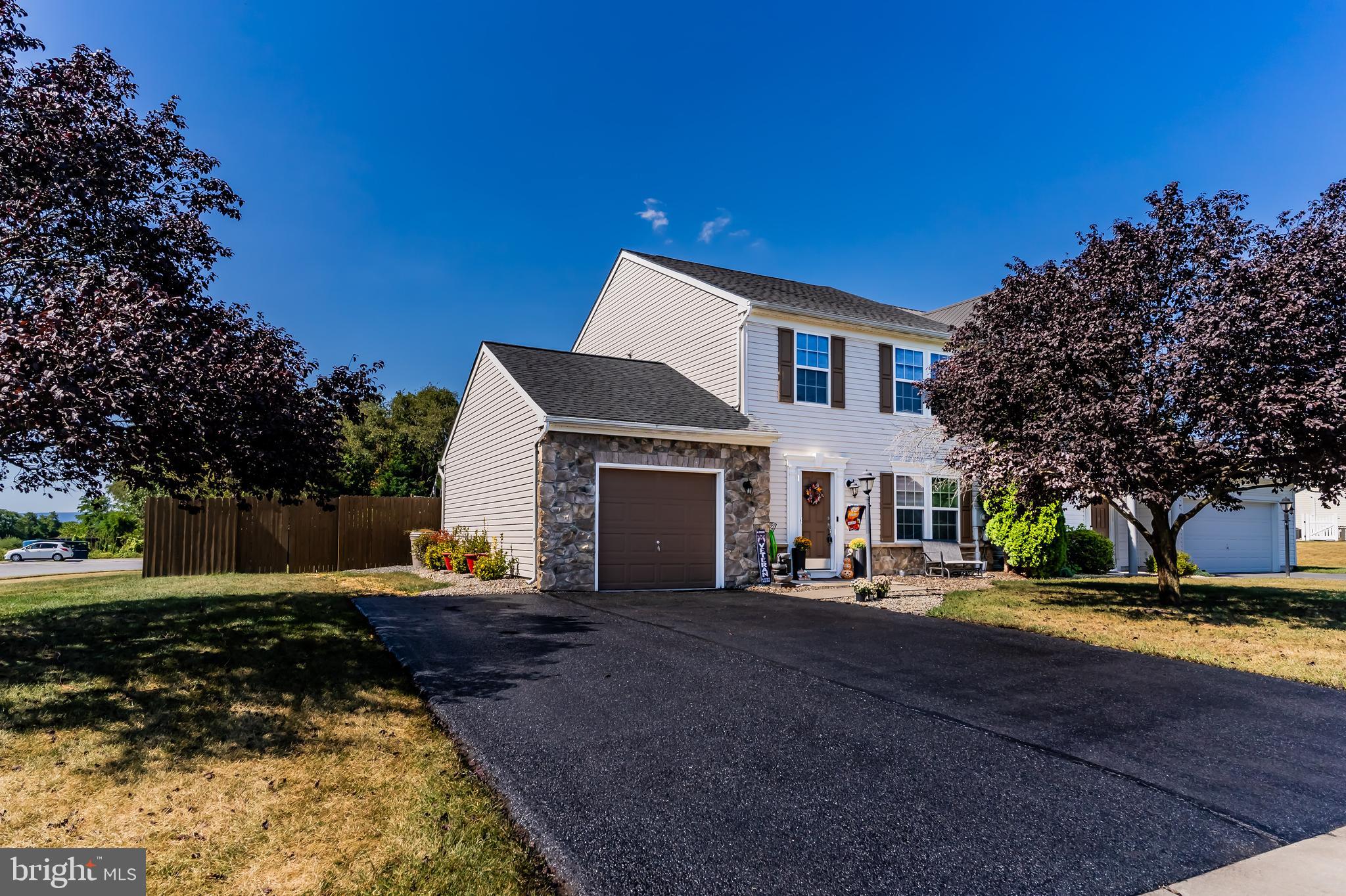 Welcome to this beautifully maintained 3-bedroom, 2.5-bath end-unit townhome perfectly situated on a spacious corner lot with one of the largest yards in the community! With plenty of windows and natural light, this home combines comfort, functionality, and style. Step inside to find a bright and open floor plan featuring a generous living and dining room combo — ideal for entertaining or relaxing evenings at home. The heart of the home is the kitchen, complete with a center island, coffee bar area, and a dedicated dining space perfect for casual meals or hosting guests. Just off the kitchen, enjoy year-round sunshine in the cozy sunroom, overlooking the backyard. Upstairs, the primary suite offers a peaceful retreat with a vaulted ceiling, walk-in closet, and a private en suite bath. Two additional nicely sized bedrooms share a full bath and are conveniently located near the second-floor laundry. The oversized, climate-controlled 1-car garage offers room for storage or a workshop, with direct access to the backyard for added convenience.