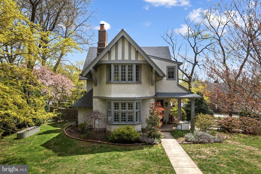 Full of storybook charm and timeless character, this distinctive Tudor Revival features original brickwork and elegant wood detailing. Set back from the street on a welcoming block in the sought-after Coopertown Elementary district, it offers the perfect mix of suburban space and urban convenience. Enjoy walkable access to downtown Bryn Mawr’s parks, trails, farmers market, shops, restaurants, and train station—all in a vibrant yet peaceful setting. Inside, a covered brick porch leads to a sunlit entryway and spacious main level. The living room features a bay window, brick fireplace with custom mantle, and built-in shelving. The formal dining room is ideal for hosting, with a classic chair rail and an easy flow into the chef’s kitchen, which is outfitted with quartzite countertops, a large island with breakfast seating, stainless steel appliances, gas cooking, an under-mounted farmhouse sink, and a generous walk-in pantry. A powder room and mudroom complete the main level. Step outside to a beautifully designed patio and fully fenced backyard, perfect for grilling, dining, and relaxing. Raised garden beds, mature trees, and additional green space in the front and side yards offer both charm and versatility. Upstairs, the serene primary suite features high ceilings, two large closets, a bay window, and a spa-style bath with radiant heated floors, dual sinks, marble tile, and a frameless glass walk-in shower. Two more generously sized bedrooms, a tiled hall bath, and a bright laundry room with utility sink complete the second floor. The third floor offers two additional bedrooms and another full bath, making it a perfect setup for guests, a home office, or flex space. The basement includes a finished bonus room, great for a den or media room, along with an unfinished area for storage or a workshop. An attached garage and asphalt driveway provide ample off-street parking. Thoughtful updates include new electric and plumbing, natural gas conversion, central air, radiant hot water heat, and public water and sewer.
With architectural beauty, modern updates, and a prime location in a close-knit, walkable community, this home offers a rare opportunity to live in comfort, style, and convenience.