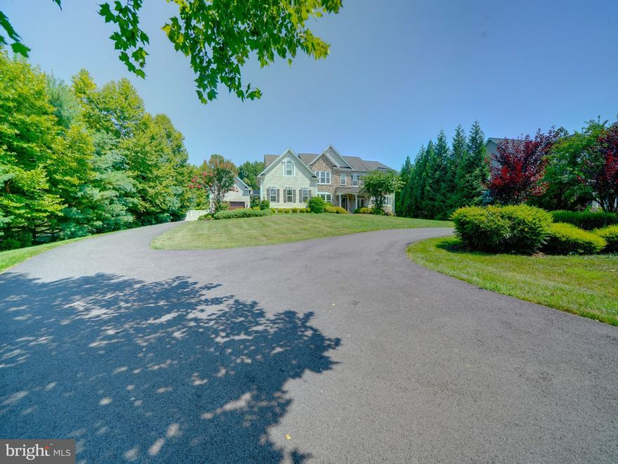 Welcome to this dream home in the heart of Glenwood, Howard County! This luxurious Winchester model built by Douglas Homes is nestled on a private 1.14 acre lot.  The home offers an impressive 8,000+ square feet of finished living space in the main house, and the newer secondary living addition built 2023.  With 6 bedrooms (and a possible 7th), 7 full bathrooms, 2 half bathrooms, this residence is generously spacious and a perfect layout for those who love to entertain. As you approach, you'll be greeted by an inviting covered slate front porch with serene views of the beautifully landscaped yard. Step inside to discover a blend of contemporary elegance and comfort. The center foyer is flanked by formal living and dining rooms, each boasting tray ceilings with accent lighting, and gleaming hardwood floors. The heart of the home is the modern two-story family room, featuring a grand stone fireplace and abundant natural light. Culinary enthusiasts will appreciate the gourmet kitchen, complete with an impressive center island, professional-grade appliances, a 6-burner gas cooktop, double ovens, two sinks and plenty of workspace. There is a main level bonus room to utilize as an office or playroom. Outdoor living is a breeze with an expansive hardscaped patio perfect for dining, enjoying a cozy fire or relaxing in the hot tub. A new vinyl privacy fence encloses the spacious, mostly level, back yard (7/24), The primary suite is a true retreat, offering a sitting room, luxury bath with soaking tub, and dual walk-in closets. Three additional bedrooms, all with en-suite baths ensure comfort for family and guests alike.  
The generous addition (2023) provides a secondary in-law or au-pair suite with its own gourmet kitchen, fifth bedroom with en-suite luxury bath, vaulted ceilings in the living area, delightful screened porch and patios – ideal for multi-generational living or hosting long-term guests. 
The lower level offers even more space with a sixth bedroom, exercise room, kitchenette, recreation area, bonus unfinished room and utility storage. Just off the main level kitchen/mudroom area is the recently epoxy coated, three car attached garage, side entry access to the additional two car detached garage and extra paved parking. Located in Clarks Meadow, this home is just minutes from local dining, Cattail Creek Country Club, parks and ball fields, MD Rts 32, Rt 70, Rt 97 and ICC. With its blend of luxury, space and convenience, this property truly offers the best of Maryland living. Your search for the perfect family home ends here!