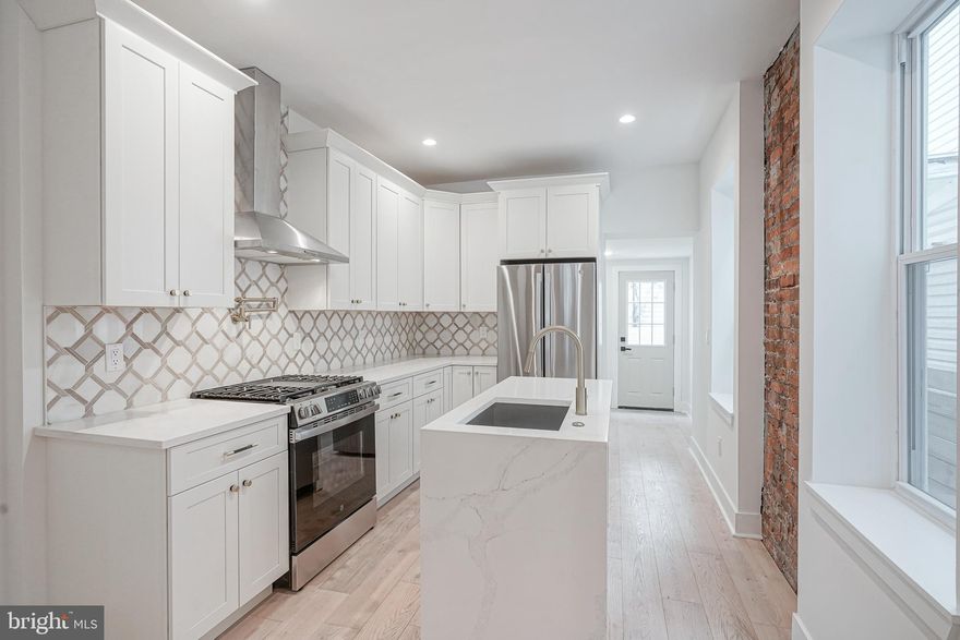 Step into this stunningly renovated home where modern design meets timeless character. Boasting 3 generously sized bedrooms,1 full bathroom, and 1 half bathroom is a one of a kind. Bathed in natural light, the sunroom is ideal for a cozy reading nook, a plant lover’s haven, or an inviting lounge area. The open-concept layout flows effortlessly into the bright living room. This spacious living room features original exposed brick accents, real hardwood floors throughout, and custom shelving perfect for decorating and storage. This room provides warmth, texture, and charm. Heading into the kitchen is the heart of the home. This beautifully designed kitchen, outfitted with sleek stainless steel appliances, high end marble, custom cabinetry, and a striking waterfall island doubles as both a functional and stylish focal point. Behind this kitchen is a half bathroom and coffee bar station. The backyard features spacious private outdoor space perfect for entertaining. Heading upstairs is 3 generously sized bedrooms and 1 full bathroom. The primary bedroom boasts ample closet space and south facing sunlight. The fully finished basement features high ceilings, additional living space, and the washer and dryer room. Walking distance to restaurants, coffee shops, and transportation you do not want to miss the opportunity to tour this beautiful home.