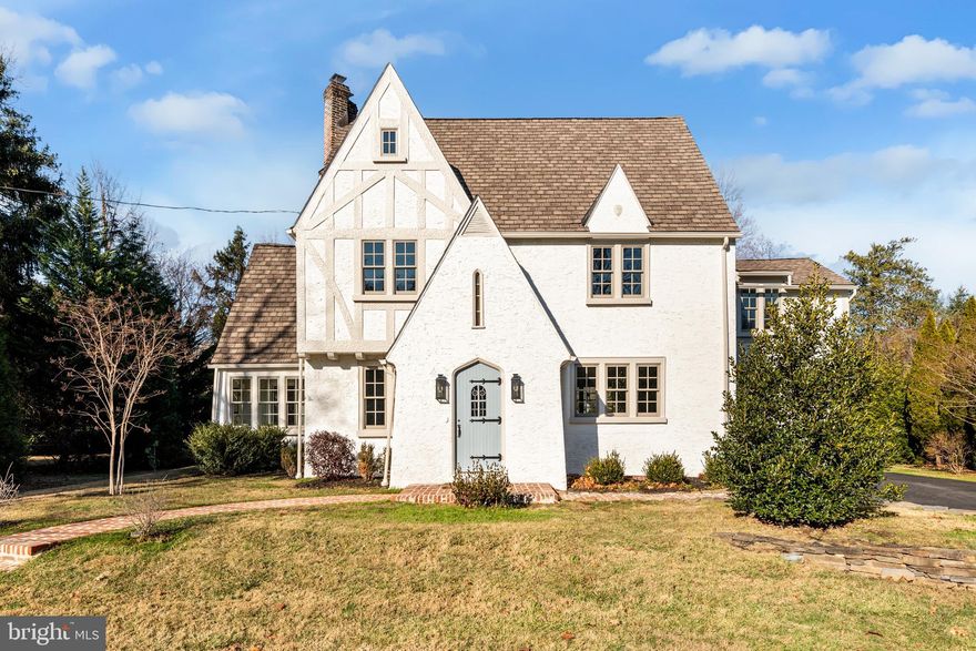 This impeccably renovated 5-bedroom, 4 1/2 -bath Tudor home masterfully preserves its old-world charm while offering a modern floor plan and amenities that cater to today’s discerning buyers. Situated on a rare, expansive .55-acre flat lot in Wayne—a notable rarity in this area—the property boasts a spacious backyard ideal for various outdoor activities.

The first floor features a custom-designed kitchen with inset cabinetry by Omega, Carrara marble countertops and slab backsplash, and a custom-built range hood. The kitchen is equipped with a La Cornue CornuFé 110 range, Shaws farmhouse sink, Bosch appliances, and unlacquered brass English hardware. The living room boasts a beautifully preserved original wood-burning fireplace and new oak hardwood floors. A standout mudroom showcases exposed stone walls, brick flooring, and an antique Dutch door leading to a newly installed custom flagstone patio. The playroom/home office/sunroom is designed with a new brick herringbone floor, offering a versatile space filled with natural light. An elegantly appointed powder room includes a reeded vanity and designer finishes.

On the second floor, the primary suite serves as a luxurious retreat with his-and-hers closets and a spacious bath featuring iceberg marble floors, a double vanity, and a large walk-in shower. Two additional large bedrooms are present: one with an en-suite princess bath with a shower, and another served by a hall bath with a tub/shower. A thoughtfully designed laundry room includes a farmhouse sink and granite countertops.

The third floor offers two additional spacious bedrooms with refinished original pine floors and a full bath featuring a large walk-in shower.

Notable features of the home include new Andersen 400 Series semi-divided light windows, new heating and AC systems, a new hot water heater, and Visual Comfort lighting throughout. A garage adds to the home’s convenience.

Meticulously blending original details like refinished hardwoods and architectural charm with premium upgrades, this home is a rare find in an unbeatable location. Situated within the esteemed Tredyffrin/Easttown School District and benefiting from low taxes, the home provides unparalleled convenience. It’s just moments from the train station and a short walk to Wayne’s vibrant downtown, farmers market, and Eagle Village Shops.