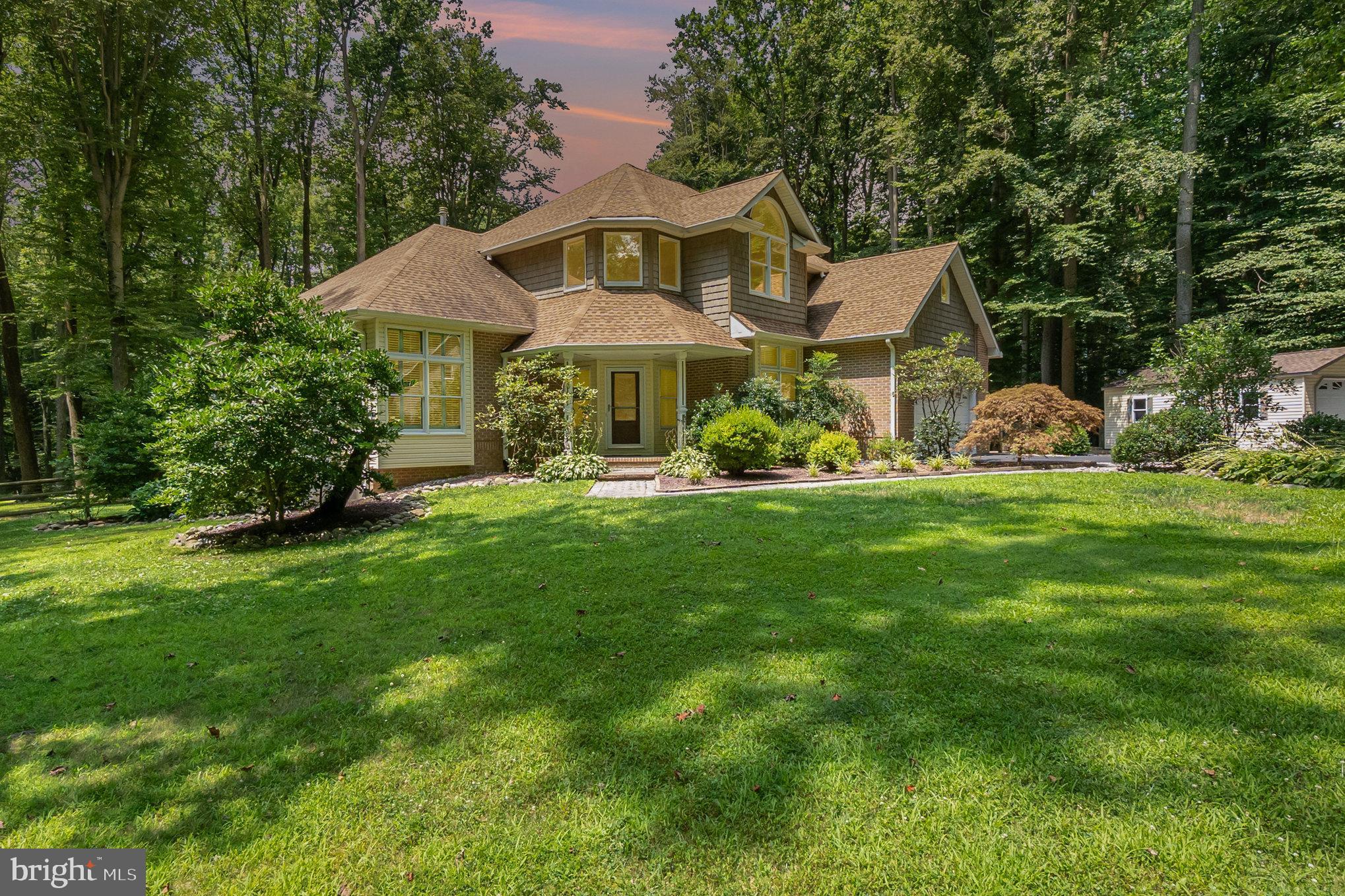 One of a kind contemporary home on 3 + acre picturesque lot. This home has been updated featuring an open floor plan with soaring ceilings, abundant windows with light filled rooms. The kitchen features 42" cherry cabinets with crown molding, quartz counter tops, tile back splash and stainless steel appliances. The great room features a floor to ceiling stone fire place. The 1st floor owners suite has a tray ceiling and a corner cylinder fire place. The owners bath is like a spa. There is a corner jetted tub, double vanity with quartz counter tops, a separate shower and a 11ft. deep walk in closet. Upstairs you will find a loft, 2 bedrooms and full bath with a new quartz counter top. The lower level is partially finished with a full bath and cedar closet. Other notable features are hardwood floors, and tiles through out, Anderson windows, large composite deck, 2 on demand water heaters, owned propane tank, 2 water treatment systems, new tile flooring, new tile in shower and bath tub in owners suite and updated light fixtures in many areas. New deck on the service garage door side.