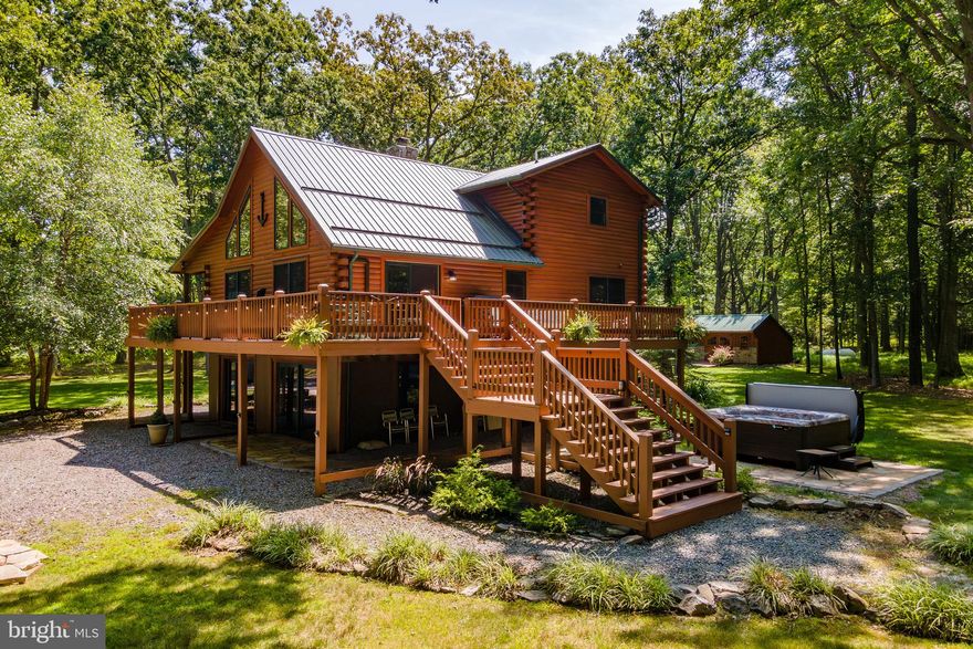 Private Lake Access Log Home at Deep Creek Lake – Nestled on almost three acres of wooded land, this 4Bed 3Bath Lodge is located just past Thousand Acres Golf Course and features a mix of rustic and modern asthenic that’s open and bright with vaulted ceilings and plenty of glass to bring in the natural beauty and abundant light. Several recent facelifts including interior paint, furniture and flooring on the lower level. Enormous wrap around deck with seasonal lake views. Homely wood burning fireplace. Contemporary kitchens and bathrooms. Fully finished walk-out basement providing ample space for lounging or a game of pool. Private Hot Tub, Outdoor firepit… plus you’re right across the street from your very own dock slip on some of the nicest lake access at Deep Creek! If you’re looking for a rustic mountain lake getaway, offering privacy that few lake homes can provide… call today to learn more!