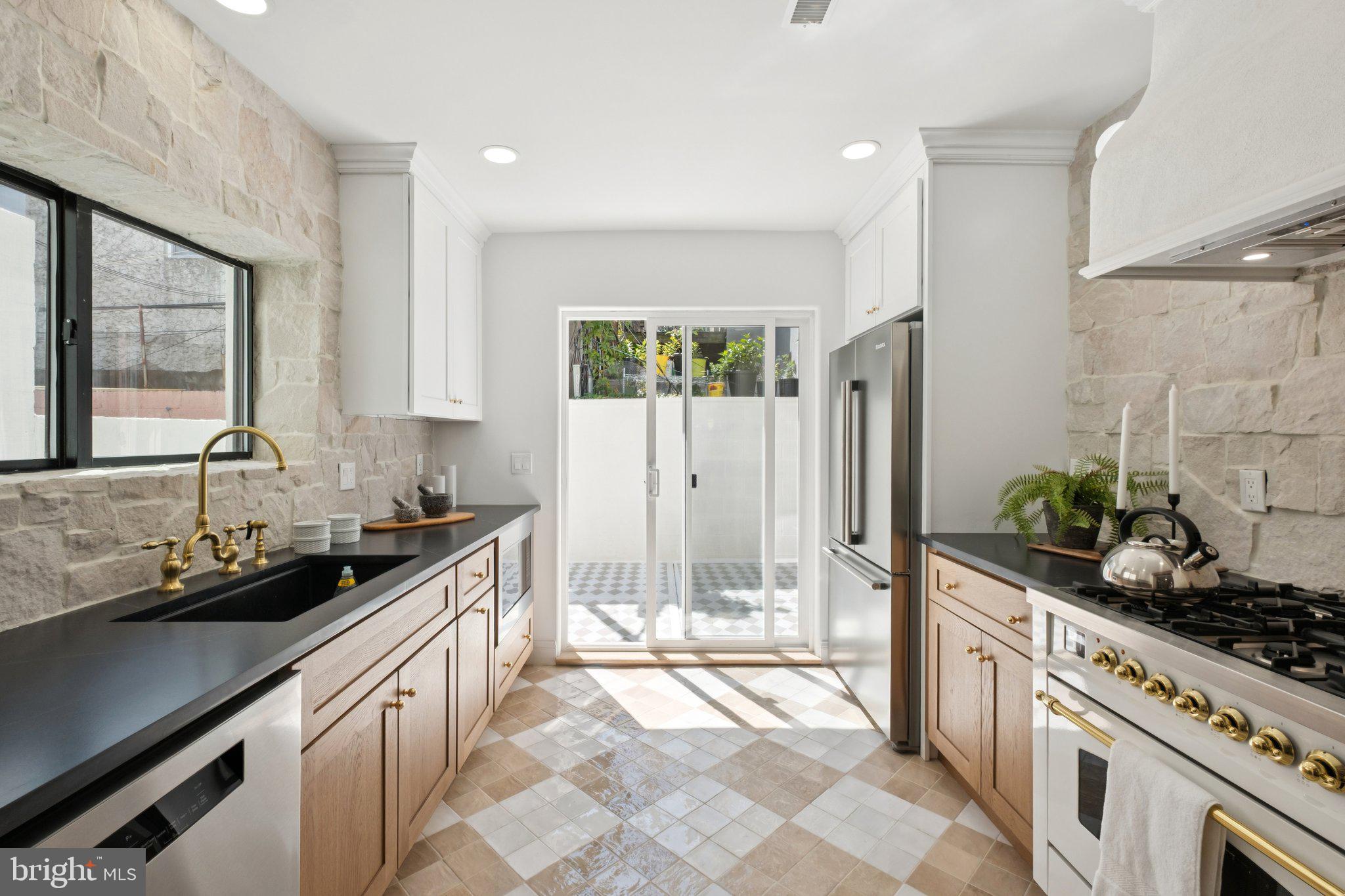 Welcome to this stunning, fully renovated home nestled in the heart of Passyunk Square. Boasting three bedrooms and three and a half bathrooms, this residence offers a perfect blend of modern luxury and timeless charm. Step inside and be greeted by an open and airy floor plan, flooded with natural light that accentuates the high-end finishes throughout. The spacious living area is ideal for entertaining guests or simply relaxing with your loved ones. Gleaming hardwood floors, recessed lighting, and large windows create an inviting ambiance that is sure to impress. The gourmet kitchen is a chef's dream, featuring top-of-the-line appliances, sleek countertops and ample storage space. Whether you're hosting a dinner party or preparing a casual meal, this kitchen is equipped to handle it all. The adjacent dining area provides a seamless flow, making it easy to enjoy meals with family and friends. Retreat to the luxurious primary suite, complete with a walk-in closet and a spa-like ensuite bathroom. The two additional bedrooms are generously sized and offer plenty of space for relaxation or productivity. The two additional full baths have also been meticulously designed with modern fixtures and finishes, providing a touch of elegance to your daily routine. To top it all off you have a finished basement and a roof top deck. Don't miss the opportunity to make this renovated gem your own.