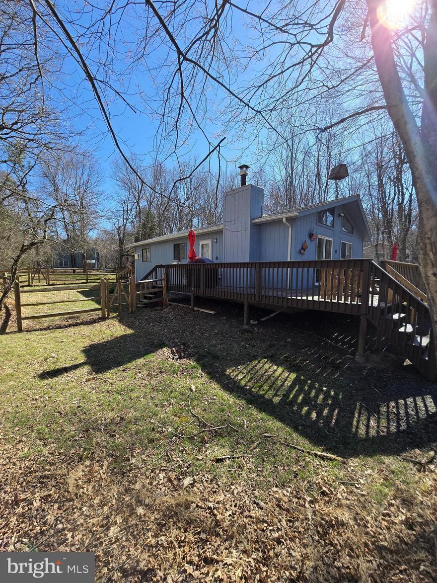 Open House Saturday 4/11 , 2-4pm and price improvement! Imagine your own escape, retreat or primary residence tucked away in the private community of Towamensing Trails, where you can golf cart to the lake or clubhouse bar & restaurant, have your own community pool, beach lake and sport courts while enjoying your private residence tucked away on a quiet dead-end non-thru street in the woods.  For under 300k!  Close to Penn's Peak, Jack Frost/Big Boulder, Jim Thorpe and Lake Harmony, and the new turnpike exit at route 903.  Two full bathrooms for your convenience, including one in the primary bedroom.  The popular open layout you desire with kitchen, dining and living area.  Nice large deck in the front plus additional 2nd, covered deck in the back with a hot tub next to it on the patio for those winter nights after snow sports or summer bbq's under the stars.  Fenced in area great for kids and pets.  Plenty of parking.  Don't miss the two videos which accompany this listing- one of which is a property walk thru and watch the other as it illustrates six amazing nearby waterfront bars/restaurants all with a view including three on Lake Harmony and Big Boulder Lake.   Shopping and grocery close by on route 903.   VRBO/AirBnB permitted!