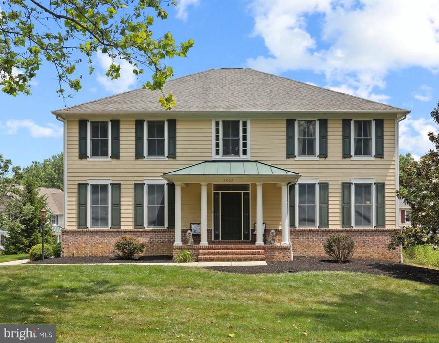 Beautiful and spacious 5 BR, 4.5 Bath two story colonial located just minutes from Main St in downtown Ellicott City.  As you walk in the main entrance, you are immediately impressed by the grand two story foyer with marble floor and six white columns. The living room and dining room have three tall windows allowing abundant light, detailed crown molding and chair rail and gleaming hardwood floors. The first floor office with newer hardwood floors, crown molding and chair rail can be accessed from the living room and hallway. The first floor half bath is located just off the foyer. The kitchen has 42" cherry cabinets providing ample space for all kitchen items and is complimented by black and stainless steel appliances including built in double oven and microwave. The Butler's pantry gives an added area when entertaining and the cook's desk is a multifunctional spot. The granite countertops, ceramic tile floor and pantry complete the upgraded kitchen which flows into the breakfast room area. The main level laundry room with utility sink is located just off the breakfast room area.  The covered rear deck is accessible from the breakfast room and is great for summer cookouts. Adjacent to the breakfast room is the spacious family room with newer hardwood floors, five tall windows, and wood burning fireplace.  When you ascend the stairs to the second floor, you will appreciate the newer hardwood floors throughout the entire second floor. The zoned HVAC system on the second level and ceiling fans assure comfortable temperatures for all the bedrooms.  The primary bedroom suite is complete with three sided gas fireplace, two walk-in closets, sitting area, and primary bath with soaking tub, walk-in shower and double vanities. The second bedroom has an ensuite bath and walk-in closet and the third and fourth bedrooms share a Jack & Jill bathroom.  The finished walk-out lower level provides additional living space and is complete with a daylight family room, large fifth bedroom, full bath and lots of storage area. Recent updates include new 72 gallon hot water heater (2021),  new hardwood floors in first floor family room and office and the entire second floor (2023 ), new second floor HVAC system (2024), and new washer and electric cooktop (2026). HOA dues is $200 annually. It has easy access to major highways including Rt 40, Rt 29 and I-70.   Come see this lovely home in a quiet neighborhood on a non-thru street just minutes from the shops and dining in Old Ellicott City.  You will not be disappointed!