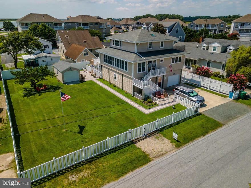 This amazing piece of property has everything you need just steps from the Marina's.  The Sale includes two parcels of land, one with the house and the second is the fenced in lot to the east of the home.  The additional lot comes with an EDU for development.  Don't miss the pool in the back with exterior kitchen, and additional storage area on the first floor level and garage   The main level is an open concept area with updated appliances, 3 bedrooms and 2 baths.  The top floor is a VERY LARGE  master bedroom that  has room to do whatever you wish.   The master bath is also very large.  Don't miss out on this custom log cabin that is like no other home in the area.