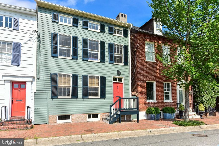 Overlooking Windmill Hill Park on one of Old Town's most sought-after blocks, this 5-bedroom stunner offers unobstructed panoramic views of the Potomac River.  Built in 1820, this historic home was meticulously renovated with improvements that incorporate modern amenities while preserving its original charm.  Original floors, interior trim, and windows have all been carefully restored to original conditions rarely found in historic homes.  Top quality Farrow and Ball paint has been applied inside and out. An expanded kitchen boasts premium appliances, Italian Carrara marble, and radiant heated floors.  Carefully hidden to preserve the home's architectural integrity, six independent climate zones were added throughout to provide efficient comfort.  A centrally located wood-burning fireplace in the dining room delivers natural heat and aesthetic appeal. Exposed historic brick, radiant heated floors, high ceilings, windows and a graduated exit stairwell will make this basement one of the most unique features of this home.  With custom cabinetry and built-ins throughout, the overall layout is both cozy and convenient, incorporating plenty of storage such as his/her master bedroom closets and an attic for storage.