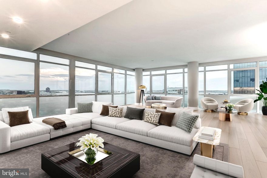 Rare opportunity to own a spectacular, one-of-a-kind, full floor Penthouse duplex in the heart of Harbor East.  Boasting over 5,000 square feet of interior living, this stunning 2-story, 4 bedroom with loft, 3.5 bath has sweeping views of the Patapsco River, the downtown skyline and Baltimore's Inner Harbor from nearly every room. The private elevator foyer opens into a breathtaking full floor residence showcasing an open-concept living room, dining room, and kitchen, airy 10-ft ceilings, designer light fixtures, solid white oak hardwood and private balcony. The custom designed Chefs kitchen features an oversized eat in marble waterfall island with seating for 5 and is appointed with Italkraft cabinetry, professional-grade Thermador appliances including a 6 burner gas range with vented wall hood and a microdrawer microwave. The luminous primary bedroom suite is a sanctuary with open southern water views, a generous walk-in closet and luxurious marble en-suite master bath with custom dual vanity and walk-in shower. The main level of the residence also houses 2 additional guest bedrooms, full bath and laundry room.  A floating staircase draws you up to the second floor where there is a secondary master suite, powder room, and expansive loft with floor to ceiling windows, gas fireplace and Wet bar that leads to the expansive 1,000 square foot private terrace creating the ideal environment for indoor / outdoor living. 2 dedicated parking spaces convey with this offering. New construction 5 year tax phase-in applies. Liberty Harbor East is Baltimore's newest luxury waterfront address. The boutique condominium offering 33 residences with stunning waterfront architecture, designer finishes, and an enviable Harbor East location atop a brand new flagship Whole Foods Market create the opportunity for the ultimate downtown lifestyle. Liberty is located in the heart of Harbor East surrounded by best-in-class dining, shopping and conveniences of downtown living. Residents will enjoy a private Concierge level with social lounge, automated and secured package room and ButterflyMX intercom security system. Residents will also enjoy access to over 30,000 square feet of private, state-of-the-art indoor and outdoor amenity spaces including a clubroom with indoor/outdoor bar, rooftop infinity pool deck with cabanas, courtyard seating, grilling stations, communal and private dining rooms with catering kitchen, fitness center, yoga studio, Pet park with dog agility and training equipment, conference rooms, study lounge with computer stations and fireplace.