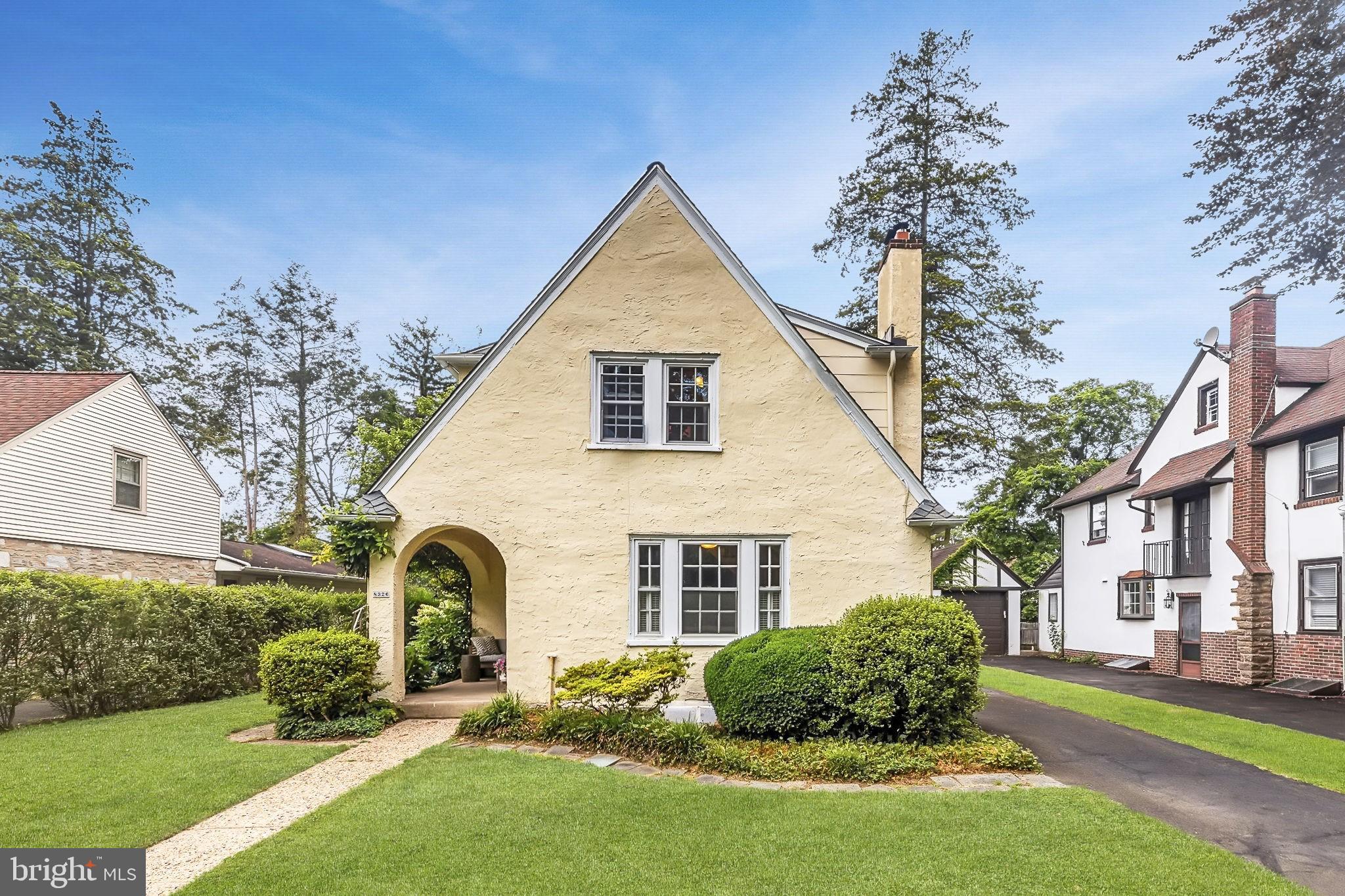 Welcome to 8326 Roberts Road—a charming, cozy home nestled in the heart of Elkins Park. Built in 1926, this beautifully maintained property blends classic character with modern updates. Step inside to find a warm living room with built-in shelving and a working wood-burning fireplace, perfect for cooler evenings. The arched doorway leads to a bright dining area that opens seamlessly to a fresh, airy kitchen featuring stainless steel appliances. Natural light pours through the classic multi-pane windows, enhancing the home’s inviting feel. Upstairs, you'll find comfortable bedrooms and a full bath, while the finished basement offers flexible living space and an additional full bath—ideal for guests, a home office, or a den.
Out back, unwind on the private patio or explore the lush, thoughtfully landscaped yard. Gardeners will love the raised garden beds, mature plantings, and tranquil vibe. Wisteria gracefully lines the front porch, and the backyard feels like your own personal oasis. The home also includes a garage and is pre-wired for EV charging. Located less than a mile from the Elkins Park train station in a quiet, friendly neighborhood, this home offers a rare blend of charm, convenience and serenity.