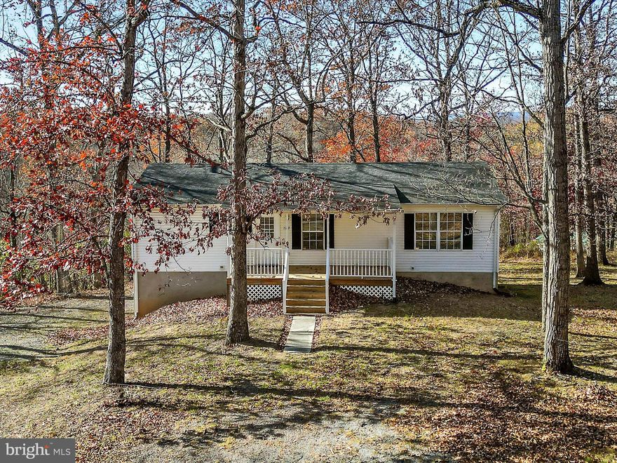 Imagine coming home to your own piece of Almost Heaven. This sweet home sits on a quiet cul-de-sac on a .82 acre lot surrounded by mature trees. Enjoy rocking your cares away on the front porch or watching wildlife from the peaceful rear deck.
Inside, you’ll find 3 bedrooms and 2 full baths. The semi-open floor plan fills the home with natural light, and the spacious living room offers plenty of options for furniture placement. All bedrooms are comfortably sized, and the primary bedroom features its own ensuite bath.
The lower level provides endless possibilities. While not a traditional garage, it makes an excellent workshop, gym, hobby room, studio, play space, or simply fantastic storage. The laundry and utility room are also located on this level. With well water and public sewer, you get the best of both worlds.
Tucked away from the hustle and bustle yet just minutes from major commuter routes, this home offers tranquility and convenience all in one. Welcome home!