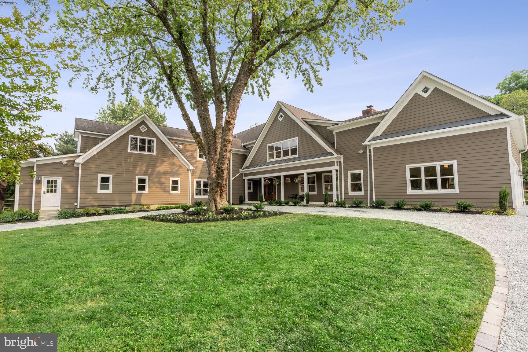 Beautiful setting on a quiet lane, this one-of-a-kind farmhouse was expanded and fully renovated in 2007. A stunning home situated on a meticulously designed and maintained landscaped 1 acre lot.
Upon arrival to the circular driveway, notice the spectacular architectural features that were masterfully crafted by the owner/designer and native Washingtonian. Step up to the IPE front porch and through the 42”antique heart pine custom made front door.
With a blend of warmth and functionality, this 7642 square feet home features panoramic views of pine and alder woods, generous natural light filled rooms with high ceilings, stone fireplaces, cherry kitchen cabinetry and a 10 foot island. All of the rooms you would expect in a luxury home, plus some incredible bonus and creative additions that will definitely surpass expectations.
Perfect for large scale events or an escape from the city, this home is a versatile entertaining haven. The kitchen features large preparation areas, stainless appliances, granite counters and custom cabinetry. Open kitchen, family and casual dining areas have easy access to the back deck and screened-in porch. Outside is a continuation of this awesome entertaining home with extensive landscaping, decking and an in ground concrete pool with automatic cover.
The main level has an in-law suite, 3 car garage and lots of storage space. Upstairs there are 4 bedrooms, all with en-suite baths (one is technically considered a den but it has a window and a closet). The primary suite is quite large and conveys with the wall mounted TV. From the primary suite you can exit via the secondary staircase after stopping into the large gym/yoga studio that is above the three car garage. Some additional features include-speakers in all the rooms, heat lamps in all baths, 8 inch heart of pine flooring freshly refinished, antique heart of pine front door, beams, columns and mantles. Solid wood interior doors. Two laundry rooms, two stair cases, side porches, stylish barn style shed.
This home boasts meticulous details throughout the interior and exterior. Enjoy the peaceful sights and sounds of nature that surround you.