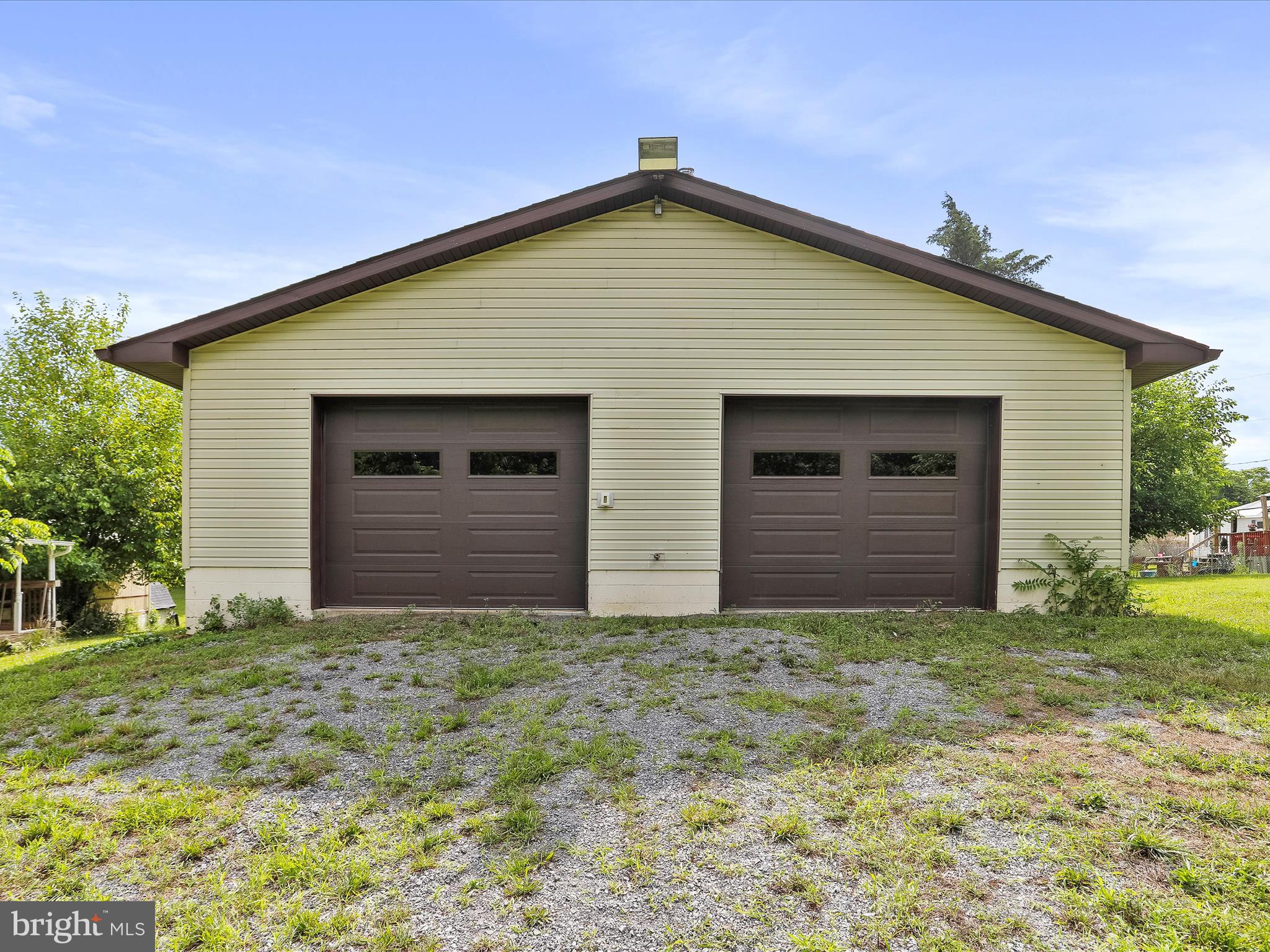 A great location to build your new home on Unrestricted 2 acres! The mobile home needs total rehab. This property offers an oversized 30x40 commercial grade garage with a high ceilings for a possible installation of a lift. 2 back rooms, one for office and 1 for a lounge. The garage has 6" concrete floor with rebar, totally insulated. Heated. Toilet is hooked into septic system. Great location for a business. Close to Interstate 81, Springfield School district. Selling strictly. " AS IS"