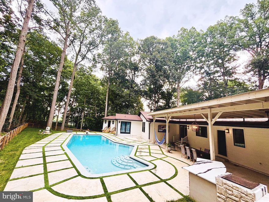 Fully Renovated Single Family Home in Sought-After Marriottsville, Howard County!

Stunning and completely renovated two-story home offering over 5,000 sq ft of finished living space. This spacious residence features 5 bedrooms, 4 full bathrooms, and multiple living areas perfect for extended families or rental income.

The main level offers an open-concept layout with a combined living room, dining room, and gourmet kitchen featuring a luxury quartz waterfall island .  Enjoy direct access to the backyard oasis, which includes a fully updated in-ground pool with new plumbing, filter system, plaster, coping, tile, and LED multi-color lights.

The outdoor area is ideal for entertaining, featuring a custom patio kitchen and plenty of space for gatherings—your own private retreat! A brand-new high-efficiency heater was just installed for the pool, so you can enjoy comfortable water temperatures all season long!

Main level also includes the owner’s suite with a luxury en-suite bath, two additional bedrooms, two fully remodeled bathrooms, and a stylish laundry room with quartz counters and waterfall edge.

The lower level includes two bedrooms, a den/office, one full bathroom, a second kitchen, and a second laundry—perfect for an in-law suite or rental potential. The home also features three wood-burning fireplaces, new windows (2022), and a new roof (2021).

A massive 2,400 sq ft detached garage with 14’ ceilings offers space for up to 10 vehicles. It includes insulated walls and doors, separate electric panel, 8” concrete floors, heating and A/C, and a new roof (2022).
Ideal for Business or Car Enthusiasts! This expansive  garage offers endless possibilities! Whether you’re looking for a space to operate your business, store equipment, or safely house your prized car collection,  it’s the perfect blend of functionality and flexibility.

Located just minutes from Turf Valley Resort, shopping, dining, and top-rated Howard County schools. Easy access to Route 32 and Route 70.