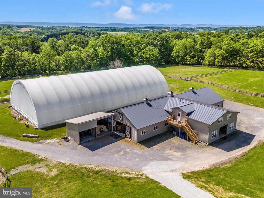 Wind your way to the heart of almost 28 acres of horse and rider dreamland.  A virtually brand new horse barn includes 16 Classic Equine stalls, hayloft, thoughtful hi velocity cupola fans for ventilation, excellent lighting, hot water wash rack, large grooming stall and feed center with laundry.  New high velocity exhaust fans maintain a healthy environment year round.   For the horse enthusiasts, a boastful lounge with kitchen and office are just steps away from the large tack room & barn  bathroom.   Efficient space for tractor storage and shavings is thoughtfully located in proximity to turnout, stalls, manure storage and even the  oversized 2 bedroom barn staff apartment.  Topping off the extensive amenities is an outdoor arena with new footing and drainage.  A 100 x 200 bluestone pad with indoor coverall arena with all new footing offers year round riding opportunities.  Paddocks are plentiful and offer run ins, shade trees and peaceful rolling countryside for enjoyable turnout.  Everything is meticulously maintained and in exceptional condition which is so refreshing!  The human side of this estate property is equally as thoughtful offering a brick colonial 3 bedroom 2.5 bathroom with a porch overlooking paddocks and pasture.  Decks and flat usable yard highlight the endless views in all directions.  A 3 bedroom 2 full bath mobile home is additional living space on the ample 28 acres appreciating sunsets and sunrises from a large deck off the side.  This property is utilitarian in its business minded training amenities and rich with additions to make work and equestrian facility living so efficient and fun.  Training horses are currently in work at this facility so we kindly request that you do not enter the driveway without an approved appointment.