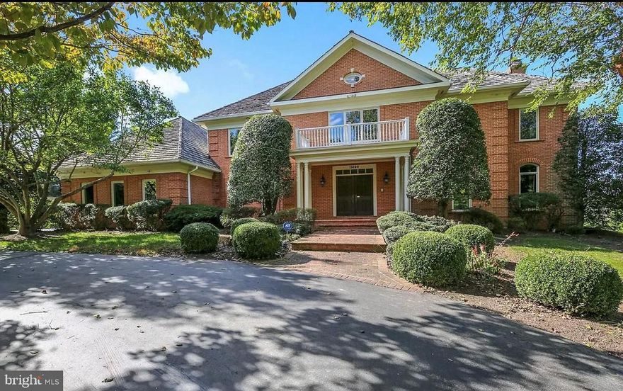 This stunning light filled 8,300 square foot all brick home sits on  a 2 acre professionally landscaped lot and offers 5 bedrooms and 5.5 baths.   An entertainer's dream  with high ceilings throughout, a lovely gourmet kitchen and breakfast area leading to  expansive deck with awning and gorgeous views! Banquet sized dining room, private office with built-ins ,  living room with fireplace and sunken family room with wet bar and fireplace. Generously sized inviting owners' suite with large sitting room/additional office with built-ins and relaxing spa bath. Spacious walk out basement with 5th bedroom and full bathroom, fireplace and bar. Huge windows throughout the whole house to enjoy the breathtaking views . 3 car garage and circular driveway. Plenty of room for pool and tennis courts. Part of the Winston Churchill High School Cluster.
