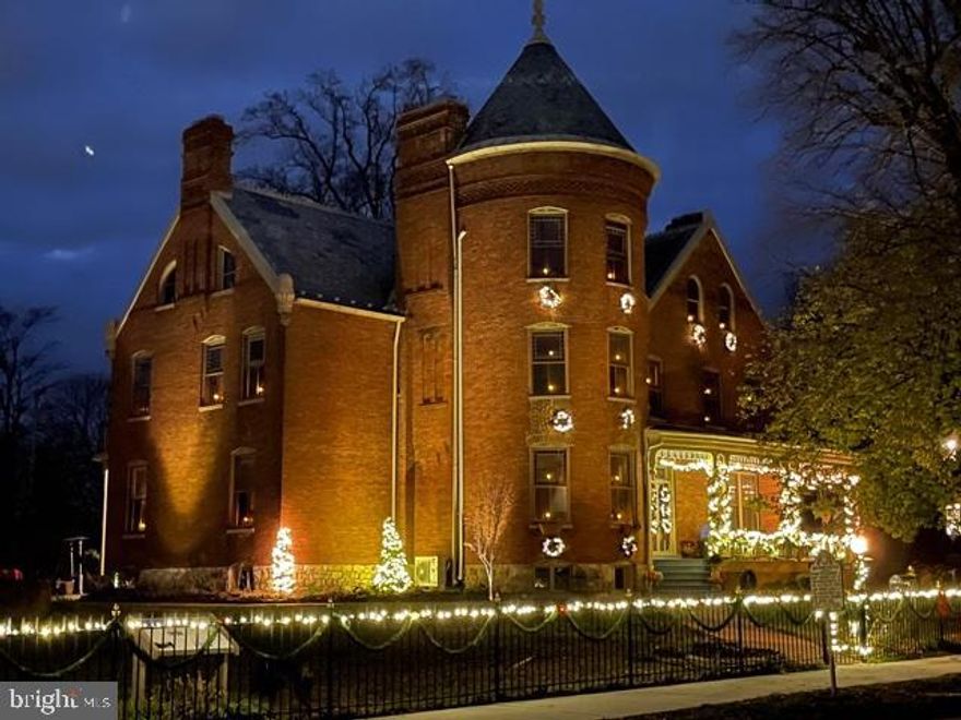 The Gibson-Todd house,  is one of the crown jewels of historic Charles Town WV, about 45 miles from Washington DC and Baltimore Md.  It is a fabulous architectural and historic treasure, 7000+ SF Victorian mansion, located on one of the old home  tree lined streets in town. It is elegant, refined and beautiful. A landmark that has housed the rich and the powerful.  It was featured in several magazines and was the site for the filming of the History Channel movie and TV production of "The Men who Made America".   PLEASE TAKE A LOOK AT OUR VIDEO TOUR   Also know that it has HIGH SPEED INTERNET SERVICE; you can work from home. 

Built in 1891 by former Confederate  Colonel John Gibson who had participated  in the arrest of John Brown and the subsequent  hanging of John Brown at the site in 1859, it sits on a elevated 1 acre lot, surrounded by elaborate wrought iron and brick walls. The dominant exterior feature of the mansion is a 113 foot tall turret. There are also  14 large  corbels  decorating the outside as well as a widows' walk accessible from 3rd story of the home.

 From the widows' walk you can see much of Charles Town in addition to the Harpers Ferry Gap, which Thomas Jefferson once said is "well worth the journey across the Atlantic".

The interior of the mansion has 3 finished floors , 5 bedrooms, 9 fireplaces ( in all rooms except one). The 1st floor fireplaces are French- laid, with elaborate mantels. There are also  stained glass windows, Waterford chandeliers and huge rooms, turret room with 19'6" ceilings. Three of the rooms within  the turret feature dramatic semi-circular walls which are a decorator's dream 

The magnificent 30' long gourmet kitchen features a commercial Viking gas range, a Sub-zero wood paneled fridge, custom cabinets and 455 SF of granite counters. The 25' formal dining room ending in the rounded turret is the prettiest we have seen. A front  bedroom also features views through the front turret windows  There are 77 windows in the home, many with louvered shutters and colored panel surrounds. One of the bathrooms features a 9' claw-foot bathtub.  There are a wonderful variety of period fireplace surrounds and mantels.

Current owners have done extensive updates to the house. 

Outside you will find an in-ground heated pool, a carriage house/garage, two wraparound porches ( one screened) and many mature trees.  The grounds include raised flowerbeds as well as a central garden and gazebo.  There is a brick sidewalk  from the street to the house.

Gibson-Todd house was previously owned by the National Trust for Historic Preservation and the Trust's extensive description of its features as well as the historic covenants affecting the property are contained in the Documents. section of this listing.  The grounds were the site of John  Brown's execution after his raid on nearby Harper's Ferry.  Former "gilded age" house guests included Amy Vanderbilt who left thank you notes penned on the walls in many of the bedrooms. This extraordinary property situated in historic Charles Town, where there are also located  several properties  associated with George Washington and his brother Charles, who developed much of the town, would, in our opinion be a wonderful, intriguing, history oriented property for tours and possibly an Air B&B.  The home is truly grand, it has been exceptionally well maintained and owning it will give any owner immense daily pleasure.  Everyone needs a home with a cupola on top. 

This is truly a once in a lifetime opportunity to own a spectacular, irreplaceable property and a significant 
piece of history.

Spectacular brick 7000+ SF Historic  Victorian mansion, 3 finished floors, 9 fireplaces. 5 BR. Tiffany window panels, Waterford chandeliers, huge rooms, 19' ceilings, gourmet kitchen, heated in-ground pool, carriage house/barn/garage 1 acre enclosed w/wrought iron/brick wall. Former National Trust Property. 21 mi  Dulles International Airport  , 4 mi MARC train.