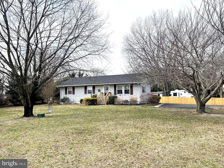 The simple pleasures of rancher-style living!! Enjoy the laid-back vibe throughout this charming, well-maintained home, new french doors in kitchen open to great-sized deck plus a concrete patio great for cookouts, perfectly sited on over 1/2 acre, large fenced yard on corner lot.  Interior layout features 3 bedrooms, 1.5 bath, eat-in kitchen, cozy comfortable size living room.   New paved driveway; upgraded flooring in living room and bedroom 3;  New wood fence; New kitchen french doors; new stove, washer and dryer.