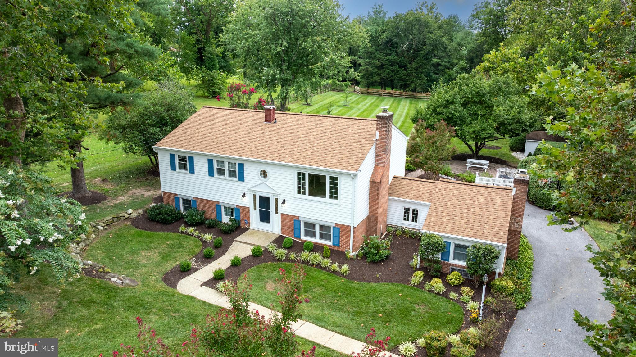 Welcome to 1200 Ridervale Road! This beautifully maintained 4-bedroom, 2.5-bath split foyer home is situated on one of the most picturesque lots in Towson. Meticulously cared for, this home offers ample space for everyday living, both inside and out. Upon entering the front door, you'll feel right at home. The upper level features a sun-filled living room with an electric fireplace (originally a wood fireplace) and a large picture window overlooking the beautiful front yard. This level also includes four generously sized bedrooms and two full bathrooms. The primary bedroom boasts two closets and an ensuite bathroom, while the other three bedrooms are serviced by a hall bathroom. The lower level is where the fun happens! The kitchen, updated in 2019 with new cabinets, appliances, and countertops, overlooks the stunning backyard and leads into the family room and separate dining room. This level also offers a bonus room that could serve as a fifth bedroom or office, a half bath, and a spacious laundry/storage room. The oversized screened porch with beautiful stone flooring extends the living space outdoors. The large, flat backyard is fully fenced and truly exceptional. The professional landscaping, brick paver patio, along with the butterfly bush, apple tree, crape myrtles, and more, will keep you outside for hours of enjoyment. UPDATES INCLUDE: Architectural Roof & Gutters 2022; AC 2019; Front Door & Walkway 2020; Floors replaced in the Den, Laundry and Dining Room in 2024. You'll love the quiet neighborhood, conveniently located near shopping, restaurants, parks, and with quick access to I-695 and I-83! This home is zoned for Riderwood Elementary, Dumbarton Middle and Towson High School. This is a special gem!