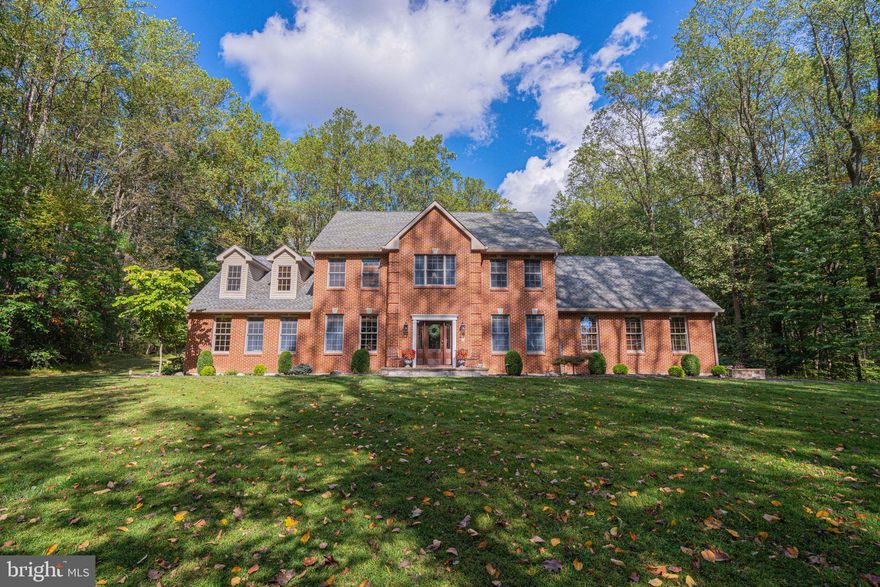Welcome to 3171 Willow Run Road—a breathtaking estate nestled on over 29 serene acres in peaceful Weisenberg Township, offering a rare blend of luxury, privacy, and versatility. Built in 2005, this stunning 5342 sq ft taped full-brick Colonial showcases refined craftsmanship, premium materials, and expansive indoor-outdoor living.  Meander up your own private and winding paved driveway and be greeted by near total seclusion as you come upon your stately brick 5 BR , 4.5 BA home.   Sun drenched spaces, gleaming hardwood floors  and radiant heated tiled floors  captivate your attention upon entry.   The expansive black granite kitchen with 42" custom Omega Cabinetry, Bosch and Sub zero appliances as well as a  Wolf double oven and range garners approval from the most discriminating of culinary extraordinaires.  Entertaining is a breeze with multiple dining spaces from the sunny breakfast nook and eat at island to the formal dining room with elegant wainscoting and hearth.  The massive family room complete with a gas fireplace and spectacular views of Mother Nature is a perfect place to cozy up for movie nights, game days and holiday gatherings ,but could easily accommodate a first floor  in law suite should the need arise. The  first-floor owners' suite with a luxurious ensuite bath, offers  privacy and the convenience of one-level living  A laundry room and additional half bath complete the main level.  Upstairs, you'll find a Jack-n-Jill bathroom connecting two well appointed bedrooms, plus two additional ensuites to accommodate  a larger family.  The library leads to the third floor finished rec room - ideal for a home theatre, game room or private retreat for nanny or teens where the mess and the noise can remain safely tucked away.  Outside,  a separate detached 6-car garage currently housing custom-built batting cages ,can  easily be converted back for vehicle storage or hobby space.  The impressive 70' x 23' insulated 3 bay metal garage, fully equipped with electric, phone and heat-ready connections - is perfect for a multitude of uses - workshop, storage, recreational or business!  Enjoy 29+ acres of rolling hills and 17 acres of open, leased farmland, providing both scenic beauty and Farmstead/Act 319 tax benefits with total taxes of $9548.70 .  Just 10 minutes to Allentown with easy access to I-78, offering seamless commuting while enjoying rural seclusion This one-of-a-kind property offers luxurious living, functional space for hobbies or home business, and significant tax savings—a true live-work estate for those who value space, comfort, and privacy. Northwestern Lehigh SD!  Plan to attend the open house Sunday Oct 12 @ 1 PM or schedule your private showing today!