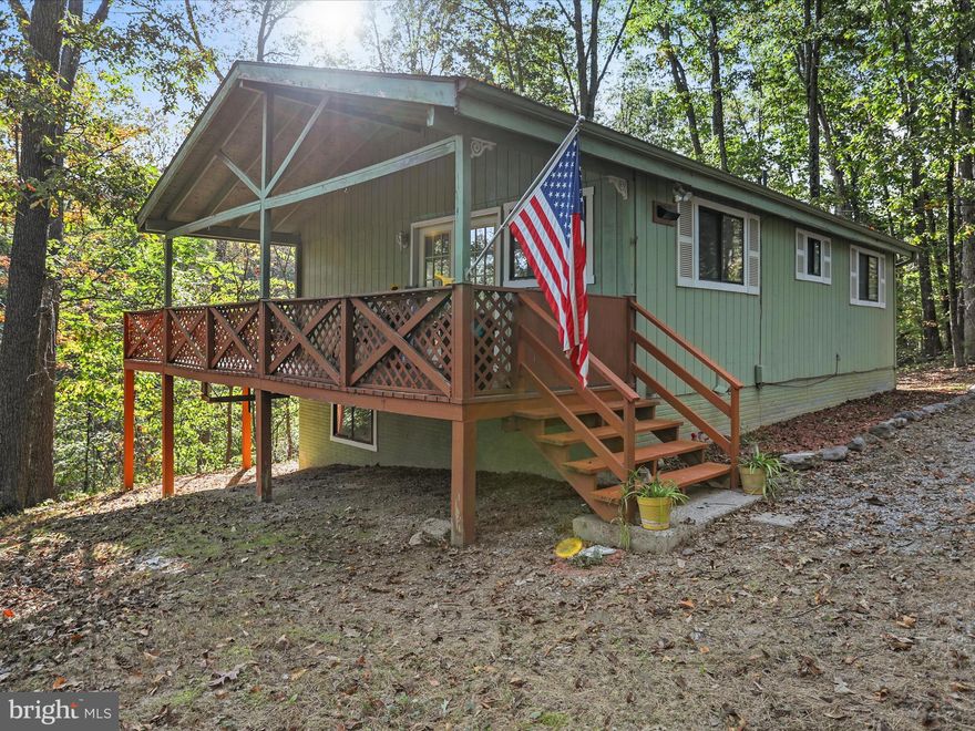 Tucked away in the woods of Glenwood Forest in Gerrardstown, WV,  this cozy single-family mountain side home is waiting for its next owners to settle in just in time for the Fall season. Featuring new vinyl flooring and paint, 2 bedrooms, 1 full bath, an open kitchen and living room with tall ceilings, a partially covered wrap-around deck, and an unfinished basement, this home is a perfect move-in-ready starter home.