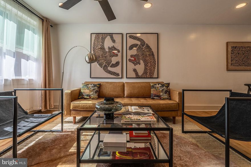 Welcome to 1015 Watkins Street, perched along one of South Philadelphia’s sweetest little blocks, complete with colorful Zagar mosaic touches, leafy trees, and the kind of friendly, low-key vibe that makes neighbors linger on the sidewalk. It’s just a short wander to the energy of Passyunk Square, giving you the best of both worlds: lively city life when you want it, and a cozy pocket of calm when you don’t.

From the street, the house makes a charming first impression. The classic brick facade and cheerful flower boxes feel instantly inviting, like a little love note to the block. Step inside and the story unfolds: bright, open living spaces, thoughtful updates, and a mix of modern polish and old-school character that feels effortlessly cool.

The living room greets you with sunlight pouring in, setting an easygoing tone for the rest of the home. The living and dining spaces connect seamlessly, framed by refinished original hardwood floors, exposed brick, and recessed lighting. It’s the kind of layout that works just as well for a lively dinner party as it does for a quiet night in.

The kitchen has been beautifully refreshed and brings together crisp white cabinetry, sleek matte black hardware, quartz counters, and a timeless marble subway tile backsplash. Beadboard wainscoting and crown molding lend a touch of classic charm that balances the contemporary finishes. Stainless steel appliances keep things modern, while a door off the kitchen leads to your own private backyard, perfect for grilling, dining outside, or hosting friends before heading out for the night. A convenient first-floor powder room means guests never have to wander upstairs.

Upstairs, you’ll find three bright bedrooms, each with closet space and its own mini-split for year-round comfort. The hall bath features a tub and a sweet corner sink that adds just a hint of vintage personality. Downstairs, the finished basement offers laundry, extra storage, and flexible space ready to become whatever you need: home office, workout area, art studio, or a cozy movie den.

And then there’s the location. Just a few blocks away is East Passyunk Avenue, often celebrated as one of the country’s best food destinations. Picture charming BYOBs, chef-driven restaurants, vintage boutiques, art galleries, coffee shops, and the kind of neighborhood spots that become your regular haunts. The Broad Street Line is nearby too, making it easy to zip anywhere in the city without thinking twice about a car.

Stylish updates, vintage charm, and a location in one of Philly’s most vibrant neighborhoods. 1015 Watkins Street is ready for its next chapter. And it might just be yours.