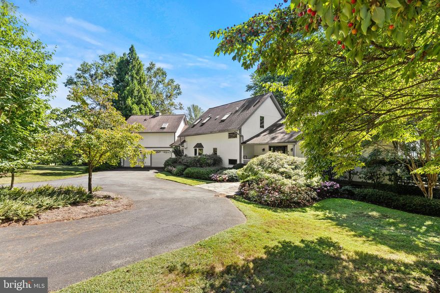 Tucked into the heart of northern Virginia’s renowned wine country, this 11-acre estate offers a rare balance of luxury, serenity, and natural beauty. The property includes a separate residential lot (6040-73-6595), creating options for expansion or a future family compound.

Set back from the road behind lush landscaping and a 50-year-old Japanese Maple, the post-and-beam contemporary home feels both timeless and connected to its surroundings. A custom Birchwood archway opens to a soaring great room with exposed beams, a dramatic stone fireplace, and floor-to-ceiling windows framing panoramic views of the pond, pool, and rolling hills. The chef’s kitchen pairs Viking commercial-grade appliances with marble countertops and decorative tile, all set against a backdrop of flowering cherry trees, camellias, dogwoods, peonies, and hydrangea.

Throughout the home, details speak to craftsmanship and character: 100-year-old barn-wood pine floors, vaulted ceilings, and skylights that flood the interiors with natural light. The main level includes a private wing with bedroom and full bath, library with reading loft, office, and a tucked-away patio retreat. Upstairs, the primary suite offers a dressing room, en suite bath, and a window seat overlooking the pond, joined by two additional bedrooms, a full bath, and a cozy reading nook. The finished lower level expands the living space with a family room, pool table, and office or sunroom that opens to the outdoors.

Designed for relaxation and entertaining, the grounds feature multiple gathering areas: a covered porch, stone patios, an expansive pool terrace with water features, and a pool house with full bath, ideal for guest conversion. A three-stall garage and outbuilding provide ample storage. Modern updates—dual HVAC systems, whole-house generator, and advanced security—bring peace of mind.

Surrounded by acclaimed wineries such as Blue Valley, Barrel Oak, and the newly rebranded Lost Mountain Vineyard, this property offers more than a home—it’s an invitation to experience Virginia wine country living at its finest.