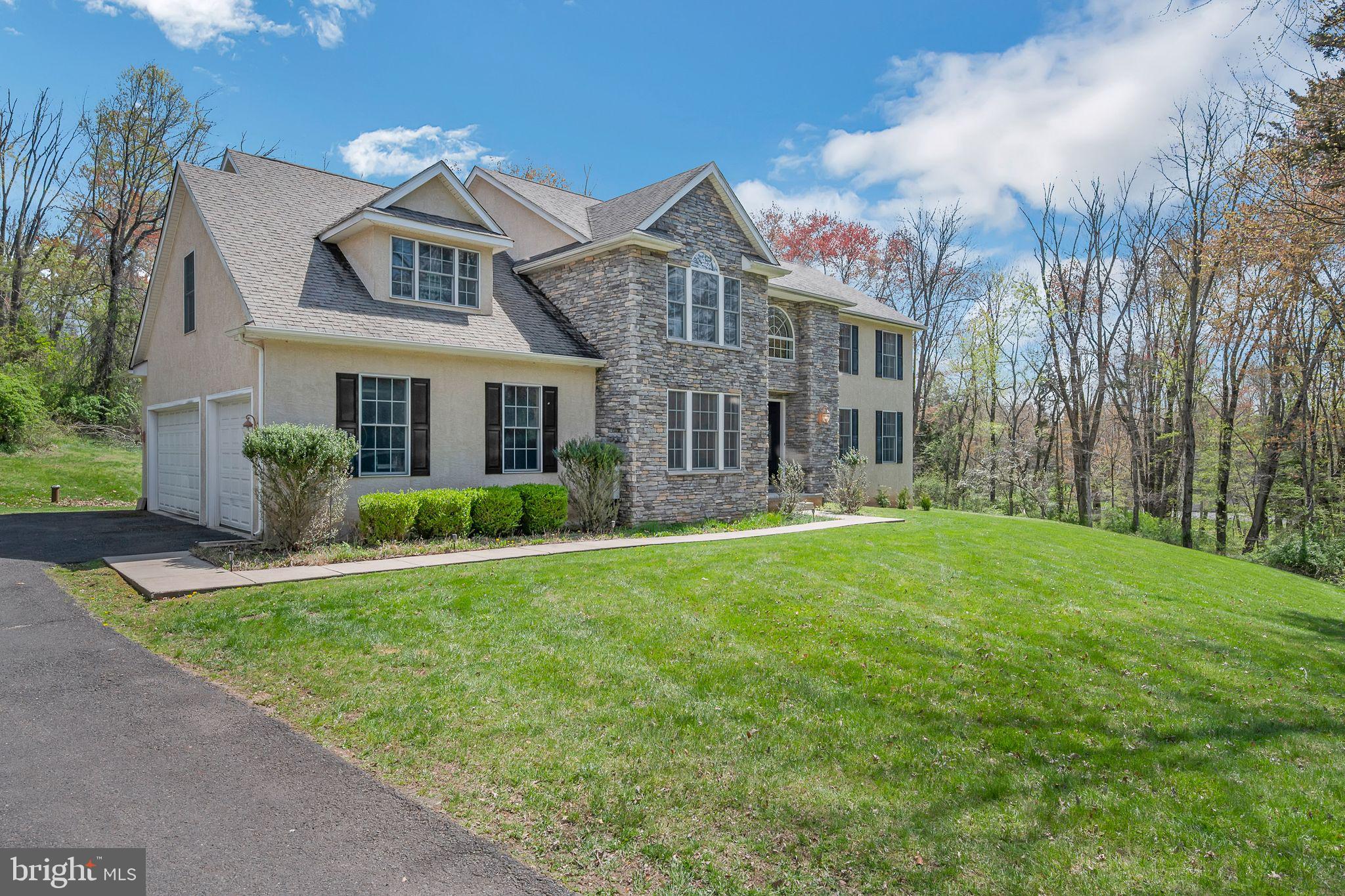 This large Staley home has 4BR, 2.5BA, is privately set with long-distance views in the Council Rock School District, and was built by a custom builder with exceptional attention to detail. Features include a dramatic two-story foyer, formal living & dining rooms with custom millwork, and a gourmet kitchen with solid wood cabinetry, granite counters, and a breakfast room. The great room impresses with soaring ceilings, custom wood beams, and a floor-to-ceiling stone fireplace. Luxurious owner’s suite with sitting area, jetted tub, walk-in shower, and dual vanity. Three additional spacious bedrooms and a full bath upstairs. A full daylight basement with high ceilings and rough-in plumbing is ready to be finished. 3-car garage, 2-zone HVAC (new 2022), hardwood floors, 9 ceilings, recessed lighting, 1st-floor laundry, central vac, energy-efficient windows, and security system. Enjoy a completely private backyard oasis—perfect for relaxing or entertaining. Close to shops, dining, and major highways, trains, and airports. This is a rare fine!