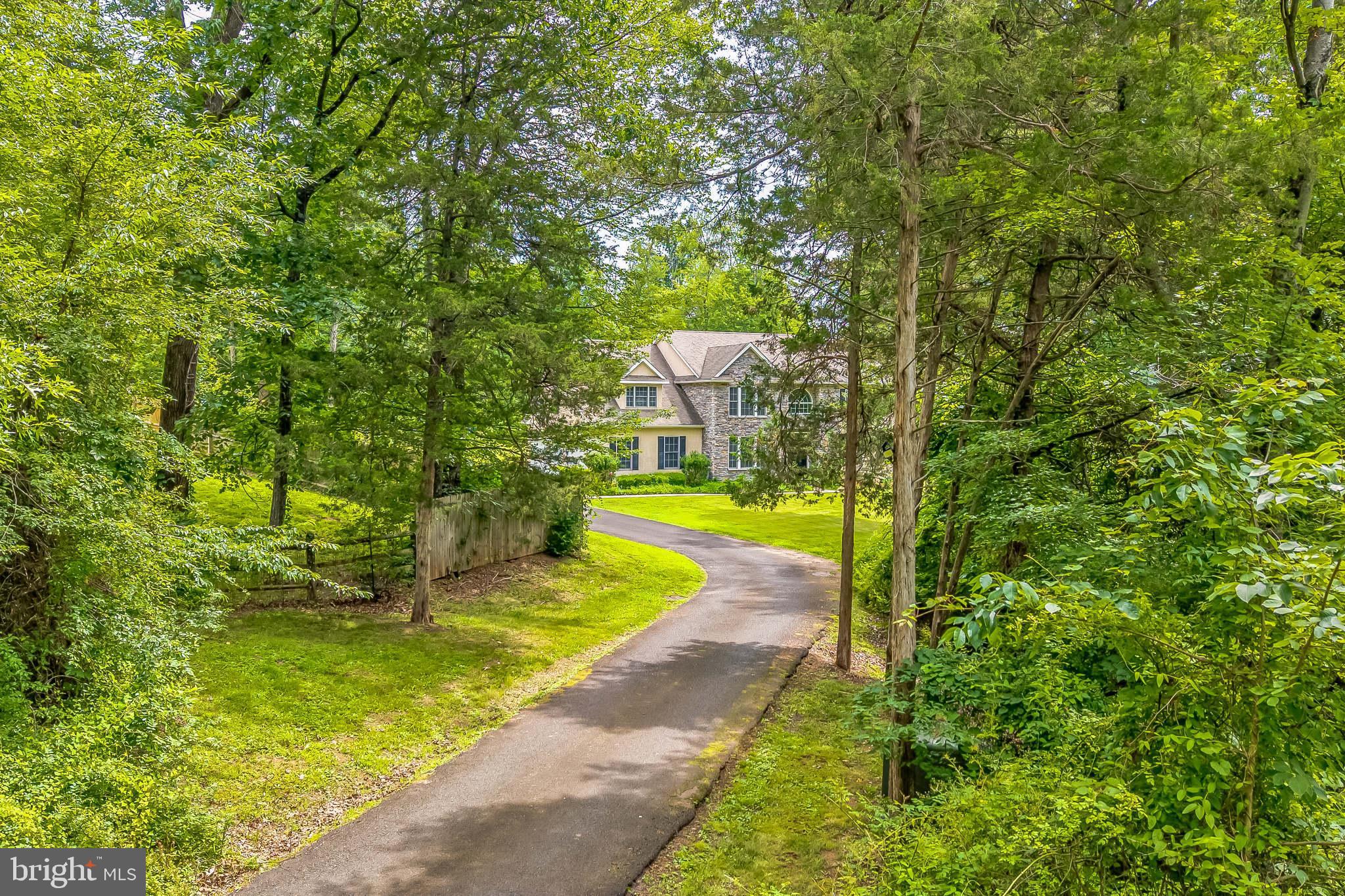 This large Staley home has 4BR, 2.5BA, is privately set with long-distance views in the Council Rock School District, and was built by a custom builder with exceptional attention to detail. Features include a dramatic two-story foyer, formal living & dining rooms with custom millwork, and a gourmet kitchen with solid wood cabinetry, granite counters, and a breakfast room. The great room impresses with soaring ceilings, custom wood beams, and a floor-to-ceiling stone fireplace. Luxurious owner’s suite with sitting area, jetted tub, walk-in shower, and dual vanity. Three additional spacious bedrooms and a full bath upstairs. A full daylight basement with high ceilings and rough-in plumbing is ready to be finished. 3-car garage, 2-zone HVAC (new 2022), hardwood floors, 9 ceilings, recessed lighting, 1st-floor laundry, central vac, energy-efficient windows, and security system. Enjoy a completely private backyard oasis—perfect for relaxing or entertaining. Close to shops, dining, and major highways, trains, and airports. This is a rare fine!