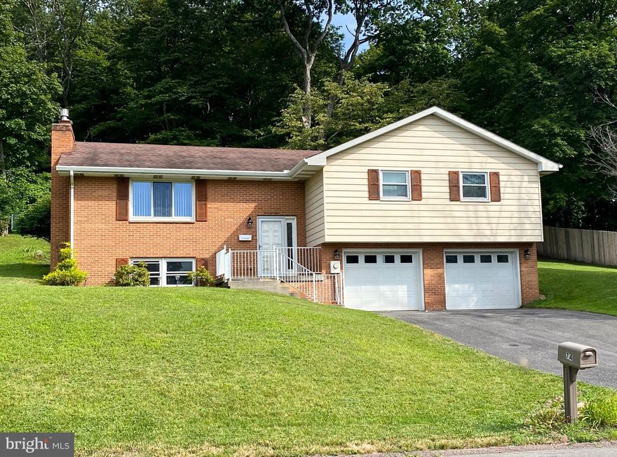 Welcome to this charming bi-level home, nestled in a desirable Frostburg neighborhood, in the scenic mountains of Western Maryland. This inviting residence offers 3 spacious bedrooms and 2 full bathrooms. The large living room offers plenty of room for gatherings.  The family room features a cozy gas stone fireplace, creating a warm and welcoming atmosphere. The eat-in breakfast nook adjacent to the kitchen provides ample space for morning meals, with enough counter space for meal prep.  A formal dining room adds elegance to special occasions.  Step outside onto the screened-in porch, ideal for enjoying peaceful evenings amidst nature.  The backyard offers privacy and tranquility, backed by a wooded landscape.  The oversized two-car garage provides convenient parking and additional storage, while the primary en-suite boasts a generous walk-in closet for your convenience.   Don’t miss this exceptional home—Call Today to Schedule a Tour!