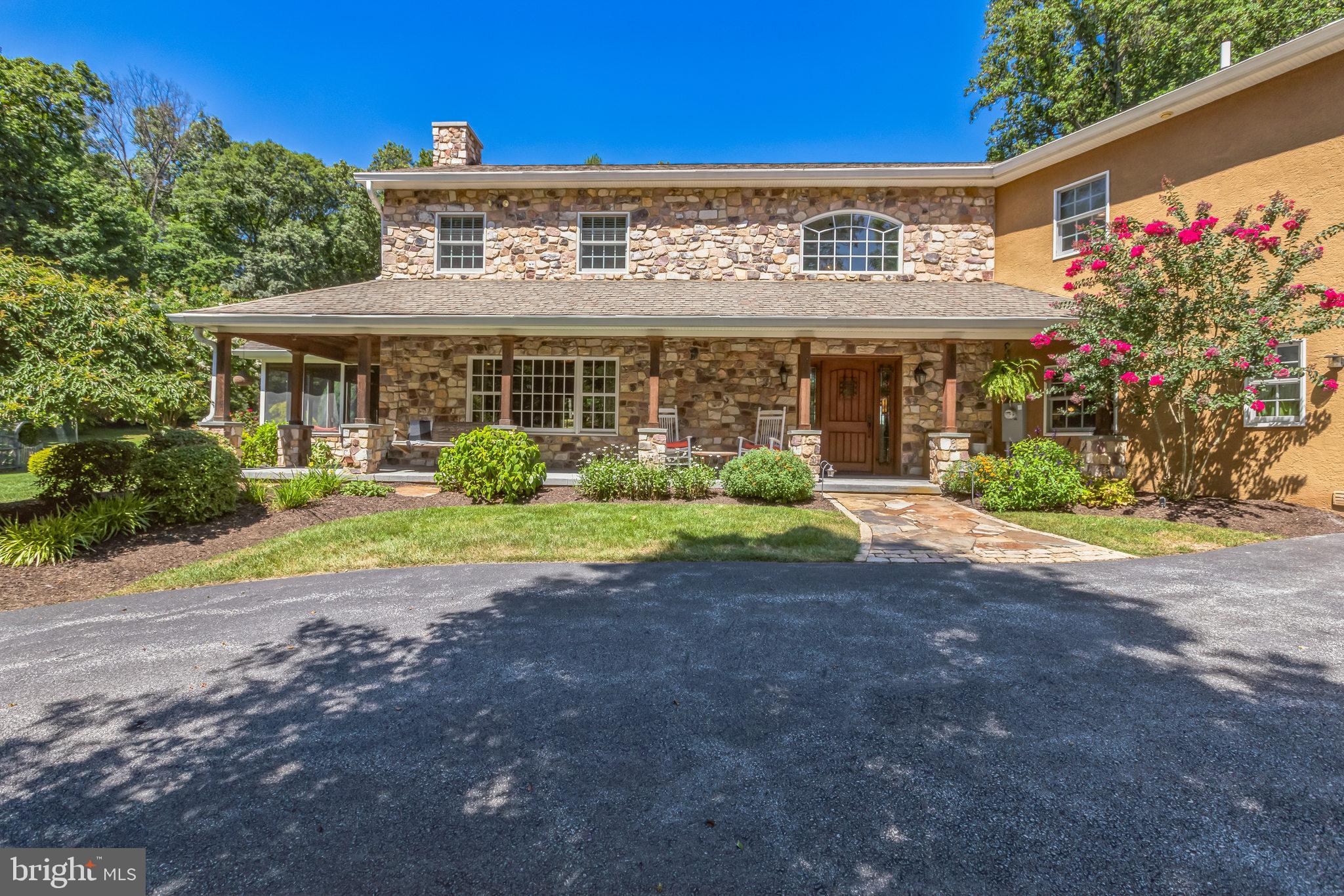 Tucked away in the heart of beautiful Glenmoore, this stunning custom-built 5-bedroom, 3 full, 2 half bathroom home offers the perfect blend of privacy, comfort, and natural beauty. Set on approximately 5.3 partially wooded acres, this one-of-a-kind property is a rare find for those seeking peaceful country living with modern amenities. The original home built in 1972 was completely redesigned and rebuilt in approximately 2006/2007. The charming front porch invites lazy afternoons with a good book or a cup of coffee before the day begins. As you head inside, you’ll find a spacious and thoughtfully designed floor plan ideal for both everyday living and entertaining. The gourmet kitchen is the heart of the home, boasting high-end, stainless steel appliances (SubZero refrigerator, Daco cooktop, Wolf oven), custom cabinetry, honed granite countertops, tile backsplash, a huge island with prep sink, separate bar area with double drawer refrigerator and sink, large pantry, and a dining area for family meals. Perfect for everyday and hosting large gatherings of family and friends! The great room invites you to cozy up around the woodstove with stone hearth and surround, while the sunroom welcomes in the natural light and views of the beautiful property. There is a first floor office for those who prefer to work from home and a guest half bath. Family and backdoor guests are greeted by a charming arched door into the mudroom with built-in drop zone, laundry closet w/ chute, and Mexican inspired powder room. The garage access is also from the mudroom. Upstairs are 5 generously sized bedrooms and 3 full bathrooms. The primary suite includes a walk in closet, cozy fireplace for chilly winter nights, and full bathroom with tiled stall shower and multiple jets. 4 additional bedrooms are serviced by 2 hall bathrooms both with dual sink vanities - one with a tub/shower combination and the other a tiled stall shower. The current owners installed miniature doors between the bedrooms to allow their children easy access to connect with their siblings. Such a fun & unique feature! The basement level is the size of the original house and is great for a game room, teenage hang-out space, or gym. Venture outside to your own private oasis—an expansive stone patio with a pergola and firepit creates a perfect setting for hosting gatherings or quiet evenings under the stars. The screened porch with a fireplace is a great spot to roast marshmallows and share ghost stories. Jump in the hot tub on a chilly night or host a big backyard barbeque with the convenient built-in gas grill with easy kitchen access. The yard is an awesome size for multiple uses - a future pool, sports/yard games, a gardeners delight, running around on ATV's or your gator. You can even have small livestock or a horse or 2 (double check township zoning). The property also includes plenty of parking for larger vehicles (you can keep your RV or boat at home), a barn, and a large shed offering excellent potential for storage and hobbies. Located within a few minutes of Marsh Creek State Park, shopping, restaurants, Hankin library, Springton Elementary and Springton Manor Farm and easy access to major roadways. All of this in the desirable Downingtown School District (West Campus) featuring the S.T.E.M. Academy. With its serene surroundings and space to roam, the possibilities are endless. This Glenmoore gem is more than just a home—it’s a lifestyle. Make your appt to see this special property today!