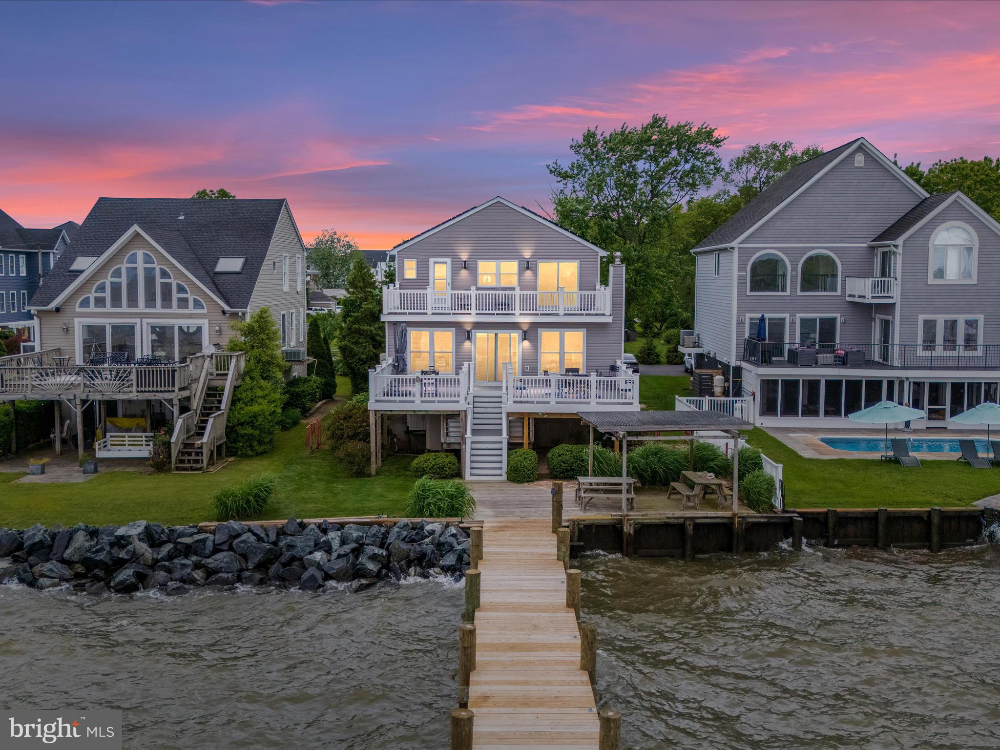 One of the best views on the bay!!This is your front row seat to coastal living. Find your serenity in this exquisite 4-bedroom, 2-bath waterfront home, perfectly situated on the Chesapeake Bay with captivating views of the Millers Island Lighthouse and passing boats. From morning coffee to evening sunsets, the beauty of the Bay will be your constant companion. Inside, you'll appreciate the stylishly updated kitchen and the two recently remodeled bathrooms. The newly renovated pier extends your living space onto the water, offering a private haven for relaxation, recreation, and soaking in the magnificent surroundings. Enjoy the outside with the various decks and porches. This is your chance to embrace the ultimate waterfront lifestyle. The entry level provides for automobile and general storage. The solar panels save on your utility expenses. There is a hook up for a pellet/wood stove behind the dining room cabinet.