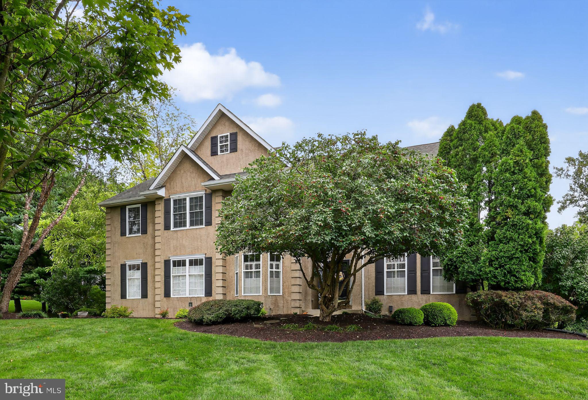 This beautiful home sits on a grassy lot backing to wooded open space and offers the perfect blend of elegance and comfort. Step into the inviting 2-story foyer with palladium windows and an open turned staircase. A first-floor office/library, hardwood floors, and a spacious 2-story family room with a raised brick hearth fireplace create an ideal setting for both everyday living and entertaining. The family room showcases magnificent palladium windows overlooking a unique E.P. Henry patio, stone-walled gardens, and a delightful deck surrounded by professionally landscaped grounds. The finished basement provides additional living space with a media room, playroom, and abundant storage. Upstairs, retreat to the true Master Suite featuring a tray ceiling, sitting room, his-and-her walk-in closets, and a luxurious ceramic tile bath with double vanity, soaking tub, stall shower, and linen closet. Three additional bedrooms share a well-appointed hall bath with double vanity and linen closet. Additional features include gas heat, central air, and a security system. Conveniently located just 5 minutes to London Grove Shoppes, 15 minutes to tax-free shopping at Concord Mall, and 35 minutes to Philadelphia Airport.