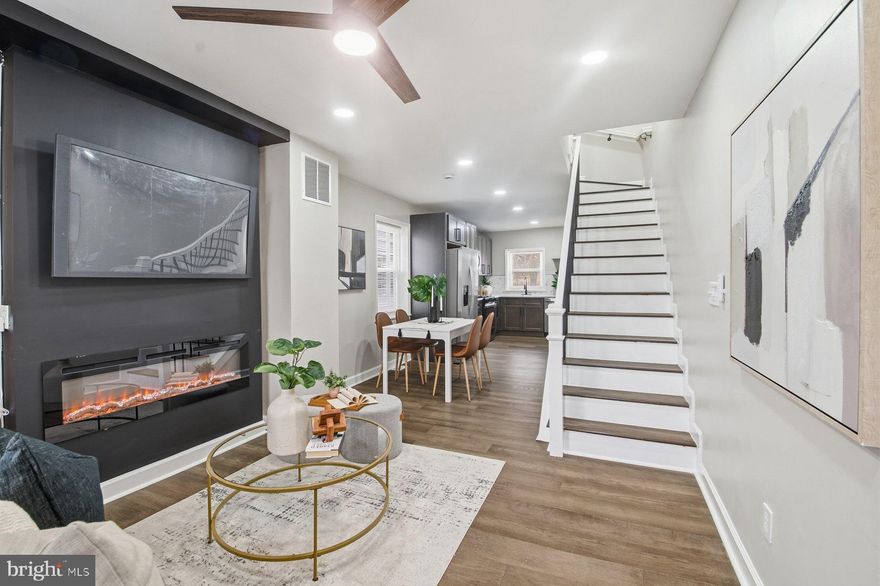 Welcome Home...This  4BR/2.5BA end of row Townhome located in the desirable neighborhood of Harlem Park.  Make your way to the front door and step inside a home completely transformed into an open main floor plan featuring recessed lighting, luxury flooring, tons of natural light, a neutral color palette and four spacious floors of living space.  The main floor features a large living room offering a custom feature wall with a gas fireplace, a spacious dining area, a half bath, and stunning kitchen. The kitchen offers plenty of cabinets including a pantry cabinet and open shelves, stainless steel appliances (like a slide-in gas range with a pot filler), sleek quartz countertops with a beautiful tiled backsplash, and a deep stainless sink under a window.  On the second floor are two sizable secondary bedrooms and a newly remodeled full bath.  The third floor hosts the third secondary bedroom, a large primary bedroom, and a full bath with a tiled walk-in shower.  The lower level is finished, newly carpeted, and offers a spacious family room, laundry, utilities, and storage. From the main floor step outside to a cozy fenced in yard ideal for summertime relaxation. Located near shopping, restaurants, and commuter routes. There are Tons of grant and down payment assistance programs available for this property based on buyer eligibility. Don't miss the opportunity to live in the heart of Baltimore.