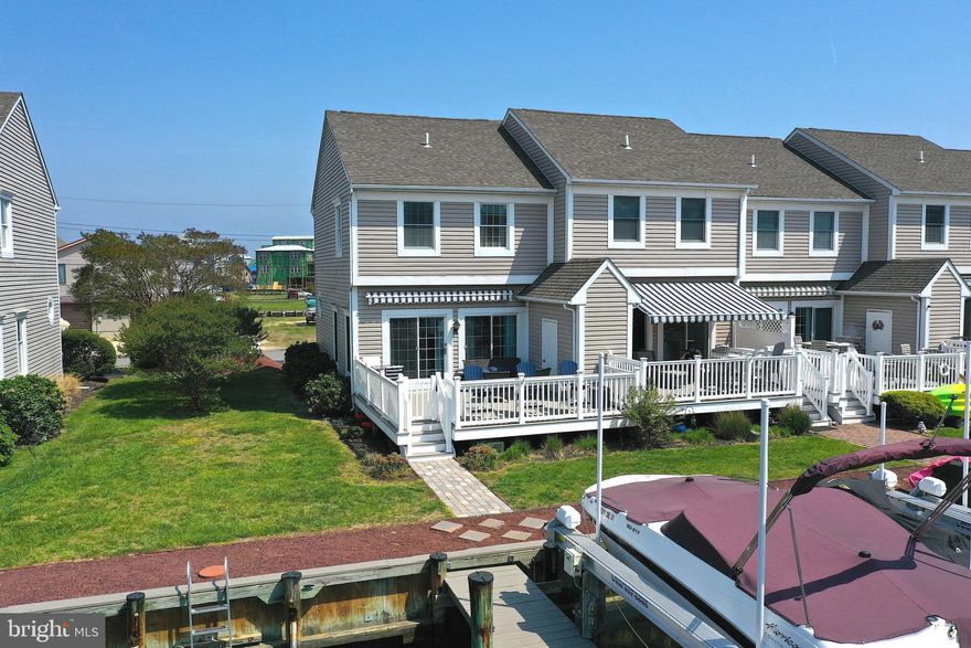 Experience the ultimate waterfront lifestyle in Ocean City, Maryland! This stunning 3-bedroom, 2.5 bath end unit townhome offers seamless access from the canal to the open bay, making it a perfect haven for boat lovers. The spacious open floor plan is bathed in natural light, creating a warm and inviting atmosphere. For those with a passion for boating, you'll love the convenience of your own boat slip right behind the townhouse, complete with a 12,000 lb boat lift and jet ski lift installed in 2021. Additionally, a brand new composite deck with vinyl railings was added in 2022—perfect for entertaining or relaxing while enjoying captivating views. In 2021, beautiful upgrades were added throughout, including an elegant granite kitchen counter and breakfast bar, modern kitchen cabinets, stainless steel appliances, and luxurious LVP flooring and a powder room on the first floor. You'll also find updated bathrooms, new ceiling fans, light fixtures, blinds, and window treatments, the entire space has been painted for a move-in-ready feel and a new water heater & two hose bibs added for convenience. Crown molding and a fire sprinkler system enhance the home’s safety and aesthetic appeal. Located on the 2nd floor is the primary bedroom with a walk-in closet and en-suite bathroom and two other bedrooms with canal views and a full hall bath. Step outside to the expansive waterfront deck to soak in canal and bay views, while secure storage provides peace of mind. With picturesque views from the living room, kitchen, and two bedrooms, this townhouse embodies the perfect blend of comfort, luxury, and waterfront living. The unit comes with 1 assigned parking space (#11) and there are extra parking spaces available. Townes of Nantucket is located just off Rt 54 only about a mile from the Ocean City & Fenwick Island beaches and this convenient location is close to many restaurants, miniature golf, a waterpark, tax free shopping in DE and there are no city taxes to pay, only county taxes. The seller will sell the 2021 Hurricane SD217 boat & the 2021 SeaDoo GTX Pro 130 hp personal watercraft.