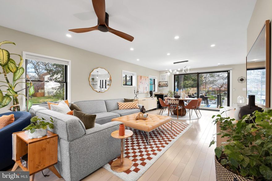 Step inside and explore this unique home - there's nothing quite like it available in Takoma Park this year. Crafted with enduring love and care, this home offers a sanctuary where practicality, style, and meticulous craftsmanship harmonize to create a serene atmosphere. As if the interior isn't impressive enough, the expansive glass wall framing the backyard will truly astonish you, offering a breathtaking view of the park-like garden that have 2 stunning cherry blossoms in full peak bloom right now. 

This home boasts a private driveway with 3 car parking, an expansive front yard, 5 bedrooms, 4.5 bathrooms, a serene backyard sanctuary, and an income-generating contained apartment. Inside, beautiful light hardwood floors enhance the brightness, complemented by abundant wood Pella windows and recessed lights for perfect balance.

The main floor features a spacious living room, dining area, and a chef’s kitchen with a unique aesthetic and remarkable functionality. Equipped with Thermador appliances, including a paneled column refrigerator (24" and 18" freezer blending seamlessly with custom-designed Kraftmaid cabinets that also features an Appliance Garage and a Message Center. Spanish Calacatta porcelain countertops extend to the wall tiles and a waterfall island edge, along with floating shelves, a 30” ceramic porcelain farmhouse sink, Kohler touchless faucets with voice control, a Hydroviv Water Filter, and a pot filler over a 36-inch Thermador 6-top burner. Additionally, there's a full bathroom and an office/bedroom on this level.

Upstairs, discover a perfect 3-bedroom, 2-bathroom layout. The primary suite offers a walk-in closet, garden view, and a spa-like bathroom with a stand-up shower and a concrete soaking tub matching the double vanity. Two more bedrooms and a hallway bathroom complete this level, along with a washer and dryer. The lower level features a unique layout, including a workshop, a second living room/bedroom, and a mudroom with exterior access to the backyard, a second washer and dryer, storage, a half bathroom, and a dog bath. Behind a hidden bookcase lies a fully contained apartment with 2 closets, a full bathroom, a Murphy bed/desk combo, a full kitchen, and separate driveway access. This rental suite generates $20,000 annually but could yield over $25,000 on short-term rentals.

This home, though not a typical stick-built construction, features a 1938 brick exterior transformed into a modern dwelling with a complete interior overhaul in 2021. The owners spared no expense, implementing upgrades like Rockwool insulation for superior insulation and soundproofing, along with new electrical, plumbing, HVAC/ductwork, a tankless water heater, and a new roof.

Externally, the house boasts touches like HardieBoard on dormers, an Acre Grain Deck, freshly landscaped grounds, a new fence, and a striking 30-foot mural by local artist Nia Keturah Calhoun. The backyard is a lush garden oasis with flowering tress and perennial flowers strategically planted to provide an ever changing backdrop with vibrant blooms from spring through the fall.  The garden has more zones than we can count and can comfortably host gatherings for up to 75 guests, offering additional income opportunities for entrepreneurs. Situated in Takoma Park's coveted "Between the Creeks" enclave, the property offers proximity to parks, community amenities, and easy access to downtown Takoma Park, Silver Spring, and transportation options including the Metro's red and forthcoming purple lines.