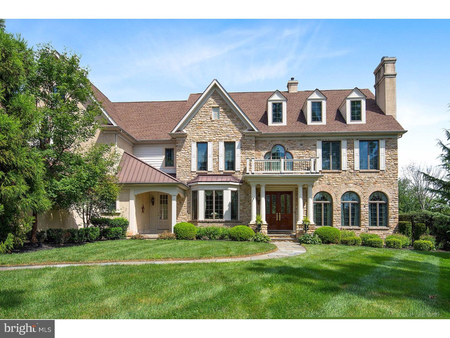 Elegant design is the hallmark of this luxurious, English manor-style home set on over two beautiful acres. Situated on a cul-de-sac, this stone-facade home was custom crafted by the Gigliotti Group in 2003 & boasts the finest in upgrades & amenities. Refined features are found throughout the almost 7,000 square foot home, from the custom millwork & built-ins, to the rich inlaid-design hardwood flooring & custom wall coverings. Step inside from the portico entrance & you'll find a spacious & elegant center hall foyer with polished marble flooring, beveled glass pocket doors, a grand staircase & French doors overlooking the wooded backyard. The elegant & bright formal living room boasts large windows, custom picture frame wall panels, custom window treatments & a gas fireplace with a hand-crafted mahogany mantle. Host elegant dinner parties with ease in the formal dining room, featuring a large bow window & custom wainscoting. A butler's pantry complete with wine refrigerator, sink & storage is just steps away. An office highlighted with a wood coffered ceiling and built-ins provides an elegant, yet private place to complete work assignments. The gourmet kitchen comes complete with top of the line appliances, granite counters, rich cabinetry & a large center island with breakfast bar. The adjacent morning room is the ideal spot to enjoy smaller family dinners. French doors from the kitchen provide plenty of light & access to an ipe deck with a remote-controlled, wind-sensor awning. Adjacent to the morning room, you'll find a cozy and comfortable great room with high ceilings and a stunning floor-to-ceiling stone fireplace. Two powder rooms complete the main floor. Continue to the main hall stairs or the back stairs & you'll find the huge master suite with sitting area, gas fireplace, large walk-in closet and a luxurious master bath with jetted tub & dual vanities. Three additional bedrooms, all with en suite baths, provide privacy for each bedroom occupant. The lower level is an entertainer's delight with a media room, game room with wet bar, exercise room, sauna and full bathroom. Back outside it's just a short walk to an outside oasis complete with a salt-water system pool, spa & pool house. Other features include attic & basement storage, a whole house generator, 4-zone heating, central vacuum system, & so much more! Enjoy elegant country living while close to shopping, schools, major roads & transportation.