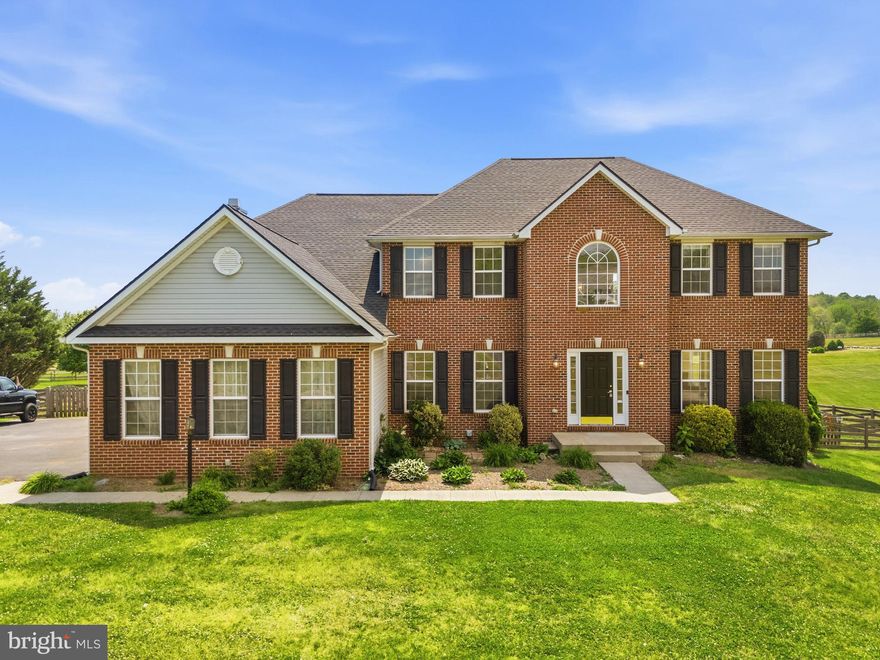 Welcome to this stunning brick Colonial set on a large lot in the highly sought-after Spruce Hill Estates community of Charles Town, WV. This home offers a versatile layout designed for comfortable everyday living and multi-generational flexibility. Featuring four bedrooms and four and a half bathrooms with a sunroom this home provides a well-balanced floor plan with room to spread out.
The interior has been thoughtfully maintained with recent improvements throughout. The kitchen features granite countertops and updated appliances, while the main level was freshly painted in 2026, creating a clean and refreshed feel. Major system updates include a new roof in 2025, heat pumps replaced in 2019 and 2022, a new dishwasher in 2025, and a recently replaced hot water heater.

This home is set on a beautiful, open lot with stunning views. The outdoor space offers privacy with plenty of room to enjoy. Conveniently located with easy access to Rt. 340 and Rt. 9, and just minutes from Washington High School, this property combines a peaceful setting with everyday convenience.