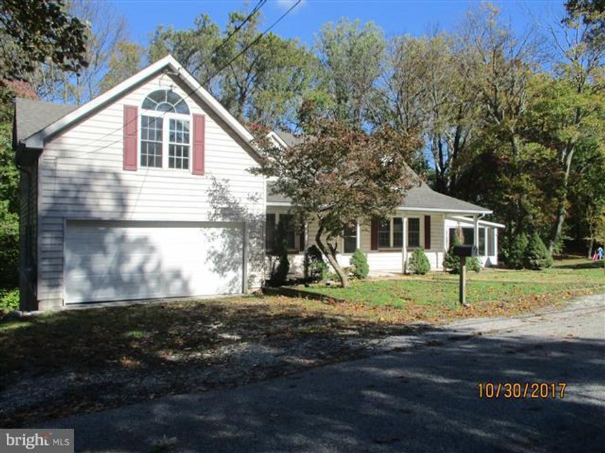 Spacious Cape Cod offers 3 levels of living space. Enclosed side porch & huge covered front porch on .53 acres. Large rear yard that backs to woods & has shed. Open floor plan on main level. Kitchen has lots of cabinet space. Main level bedroom or use as office & powder room. Upper level has master bedroom with private bath & 2 other bedrooms. Lower level has huge family room with fireplace.