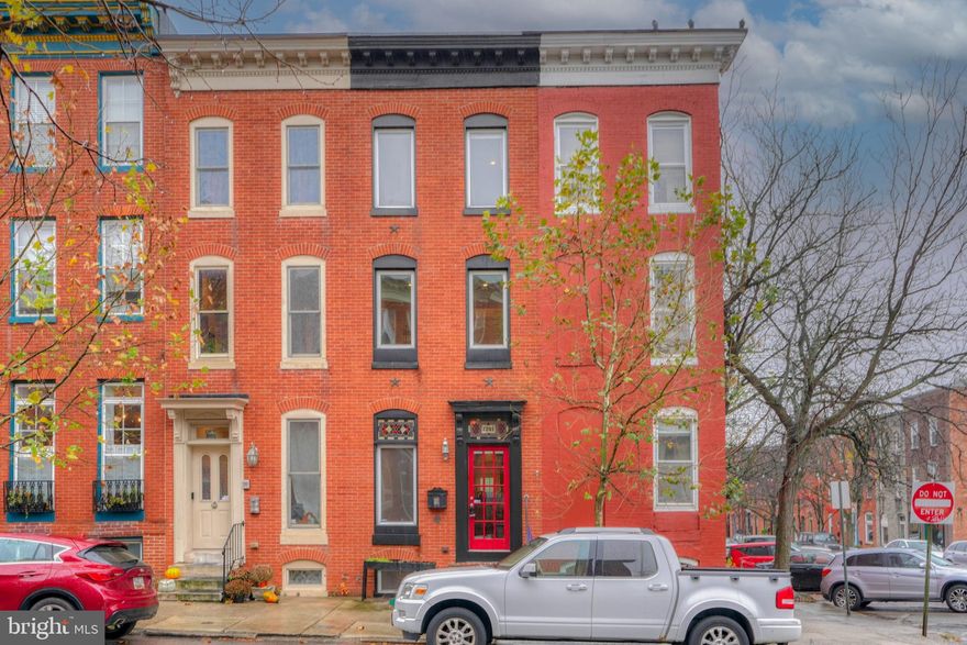 2201 E. Lombard St. is ready for its new owners. The unique loft design of this Butchers Hill home stands out immediately as you enter. A very spacious living room is in the lower level as well as a convenient half bath and laundry room. There is also a concreted storage crawl space which is great for additional storage. On the main level is the kitchen offering black ad stainless steel appliances. There is even room for a small table & chairs for breakfast and casual meals. Beyond the kitchen is a separate dining room that also has a breakfast bar.   Just off the dining room, outside the French door, is a cozy deck and backyard.
On the second level are two bedrooms with nice closet space. The rear bedroom offers a deck overlooking the rear yard. There is also a hall bath. At the top of the third-floor stairs French doors lead you to the primary bedroom which boasts vaulted ceilings, a dressing area, and skylights. Additionally, there is an ensuite bathroom with a separate shower and bathtub. A couple of the finer details include stained glass transoms, exposed brick on all levels!
 Take pleasure in knowing your unique home will be the topic of all your gatherings and you will be living in such a great community conveniently located close to neighborhood restaurants & shops, Johns Hopkins, The Shops at Canton Crossing, Canton Square and only 1/2 a block from Patterson Park!