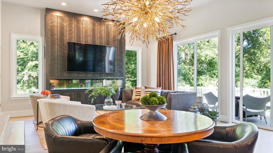 Peace, tranquility, and convenience! If you are looking for serenity and elevated living with easy access to Chevy Chase, Kensington, Bethesda, and DC - look no further! This stunning, professionally decorated End Unit townhome with elevator in Chevy Chase MD offers luxury finishes in a private, park-like setting, abutting Rock Creek Park's nearly 1700 acres of protected woodlands and streams.   Multiple outdoor living spaces allow you to take in the incredible landscape. The towns of Chevy Chase, Kensington, and Bethesda are accessible within minutes and offer incredible dining and shopping options.

This end unit townhome is flooded with natural light and its open concept design makes entertaining a delight. The main level of this home features a showstopping custom bar area with steel and glass doors, designer sourced tile, a wine refrigerator, and refrigerated beverage drawers. The stunning chef's kitchen is outfitted with top-of-the-line appliances, custom marble countertop surrounds as well as a large center island complete with waterfall edge and seating. There is ample space for a large dining table in the kitchen as well. A spacious outdoor veranda, which overlooks parkland, is easily accessed from the great room and has an outdoor wet bar with a refrigerator, seating and dining space, and a custom remote-controlled retractable awning. A gas hookup makes barbecuing a breeze - no more running out of propane during meal preparation! The powder room with grasscloth wallpaper and a custom vanity completes this main level.

Take the elevator (with upgraded interior) or the stairs to the upper level where you will find a large principal bedroom with 2 walk-in closets with custom storage design, as well as the primary bathroom complete with a stunning primary bathroom. The hall bathroom serves two additional bedrooms, all with professionally designed finishings. The conveniently located  laundry area is also found on this level.

The lower-level bedroom/rec room features a wall of windows and soaring ceilings and has its own full bathroom. This room features french doors that lead out to a peaceful patio area overlooking Rock Creek
Park.

This house is an absolute 10++, the attention to detail both in the building of the property and the interior design is unrivaled in the area and should not be missed!