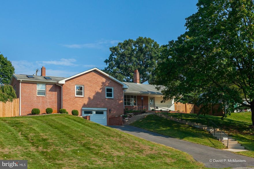 Amazing in town opportunity.  Spacious all Brick Rancher with covered front porch over looking Jefferson Memorial Park, Walking Path, Tennis Courts and Pool!  TWO garages.  Two Drive Ways.  Rear access with huge flat concrete and asphalt driveway.  Gravel pad for parking trailer or RV.  Brand New Fenced in rear yard.  Small fish pond.  Paver Patio.   

Open airy floor plan on the main level with Hardwood Floors.  Kitchen has a huge island.  Granite Counter Tops, Pendant Lighting.  Adjoining great room has beautiful built-ins and wood burning fireplace and a huge bay window looking out on the park.

Master Bedroom has walk in closet and private master bath with double vanity, tub and separate shower.  All 3 bedrooms are on the main living level and all have hardwood floors.

Oak stair case leads to finished lower level which includes an awesome recreation room with wood-buring fireplace with huge brick hearth.  Additional bedroom with walk up exterior egress and a 3rd full bathroom. 
 There is an unfinished storage room and a 2nd garage.