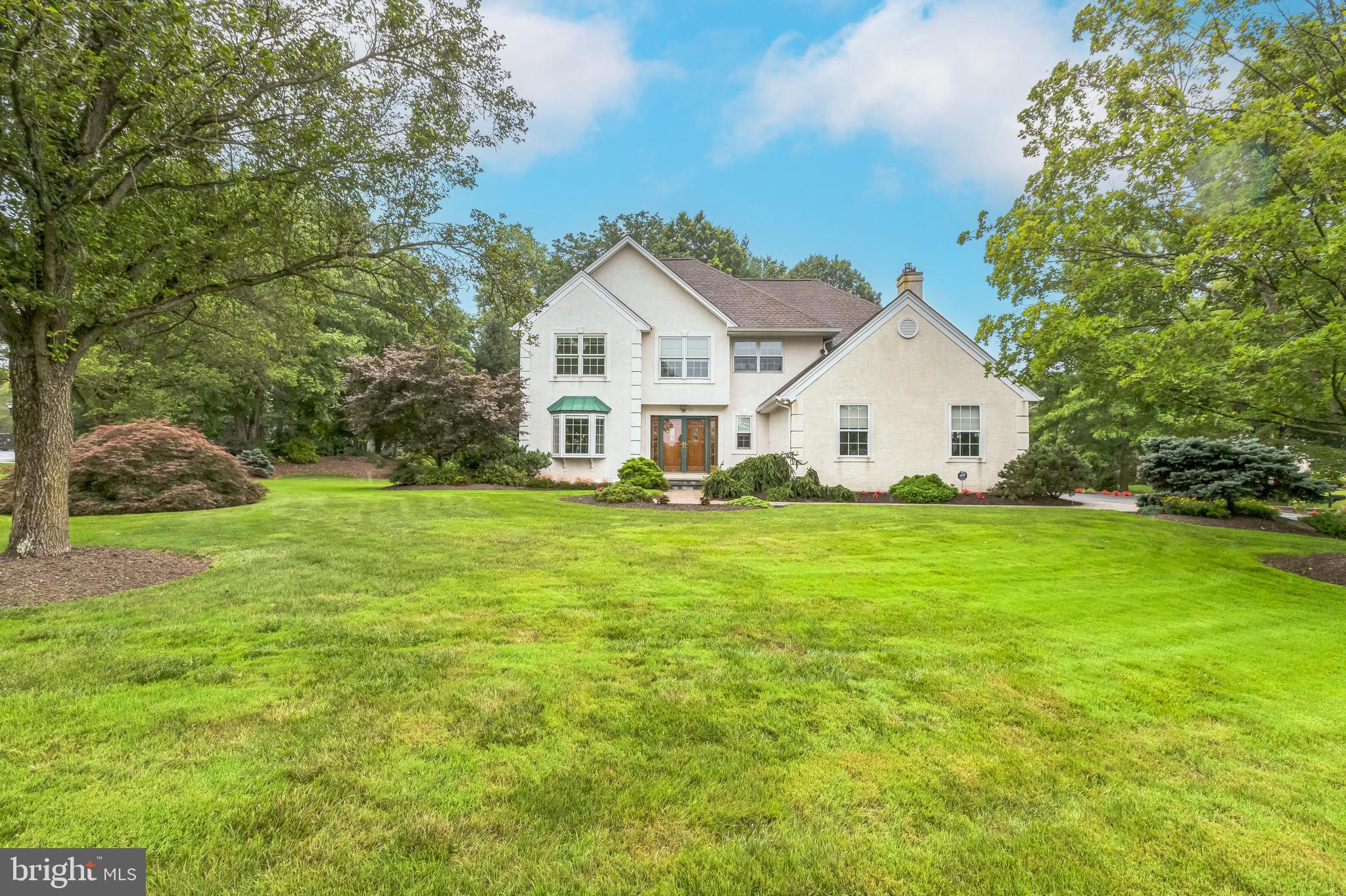 Welcome to this beautifully updated and impeccably maintained home, perfectly situated in picturesque Buckingham Township, Doylestown. Blending classic charm with thoughtful modern updates, this home offers comfort, style, and convenience. From the moment you arrive, the meticulous landscaping and timeless architecture create a warm and welcoming first impression. Inside, gleaming hardwood floors flow seamlessly throughout the home, adding warmth and timeless appeal to every room. The 2-story foyer leads to the well-appointed, comfortable living room with bay window and adjacent dining room perfect for hosting holidays with family and friends. The updated kitchen is bright and functional, featuring Corian counters, tile backsplash, updated cabinets inside and out, stainless appliances, recessed lighting, a peninsula with seating and a spacious breakfast area. Enjoy views of the lovely backyard with specimen plantings and wildlife sightings while working at the sink or enjoying coffee at the breakfast table. The kitchen is open to the fireside family room with gas fireplace and custom cabinetry, providing the perfect spot to gather and unwind with your favorite TV show or good book. For those who love outdoor living, the screened-in porch and adjoining patio offer serene spaces to relax, dine, or entertain, surrounded by lush, professionally landscaped gardens that enhance the beauty and privacy of the property. With an infrared heater, with mounted thermostat, and wiring for television, many game days and family meals have been enjoyed, bug-free, in this space with family and friends! The pretty powder room and convenient laundry room, with access to the 2-car garage with insulated garage doors, complete the main level. Upstairs the primary suite is a retreat any time of day. Appointed with a tray ceiling, crown molding, recessed lighting, ceiling fan, walk-in and linen closets and recently renovated full bathroom where modern luxury meets comfort with high-end finishes and a serene spa-like design. Enjoy relaxing mornings and evenings in this thoughtfully updated retreat. The gorgeous primary bathroom offers a large walk-in tiled shower with frameless glass surround and bench, beautiful custom cabinetry with granite counter tops, water closet with pocket door and additional cabinetry, a makeup vanity, recessed lighting and temperature controlled, radiant heated tiled flooring. The 2nd floor offers 3 additional spacious bedrooms all with ceiling fans and closets. The hall bathroom has also been tastefully renovated with attention to detail, offering fresh, contemporary style while preserving the home’s classic feel. The full basement is dry and perfect for gym equipment, workshop and storage. In addition, there is a storage shed to house yard equipment which allows both cars to fit into the 2-car side entry garage. The attention the current owners have paid to every detail in their home cannot be overstated. There is a full house Generac generator with 30 year warranty (installed 2019), Roof replaced (2017), HVAC (2015), Pella windows and doors on front of home (2008 - except garage) , Pella door in Family Room (2011), an automatic light lift for the foyer light, a security system serviced through ADT, plantation shutters and automatic blinds, hardscaping/retaining walls, etc. There is nothing to do here but move in and enjoy your new home! Conveniently located to walking trails, Bush and Hansell parks, schools, shopping and restaurants. Don’t miss your opportunity to see this special home!