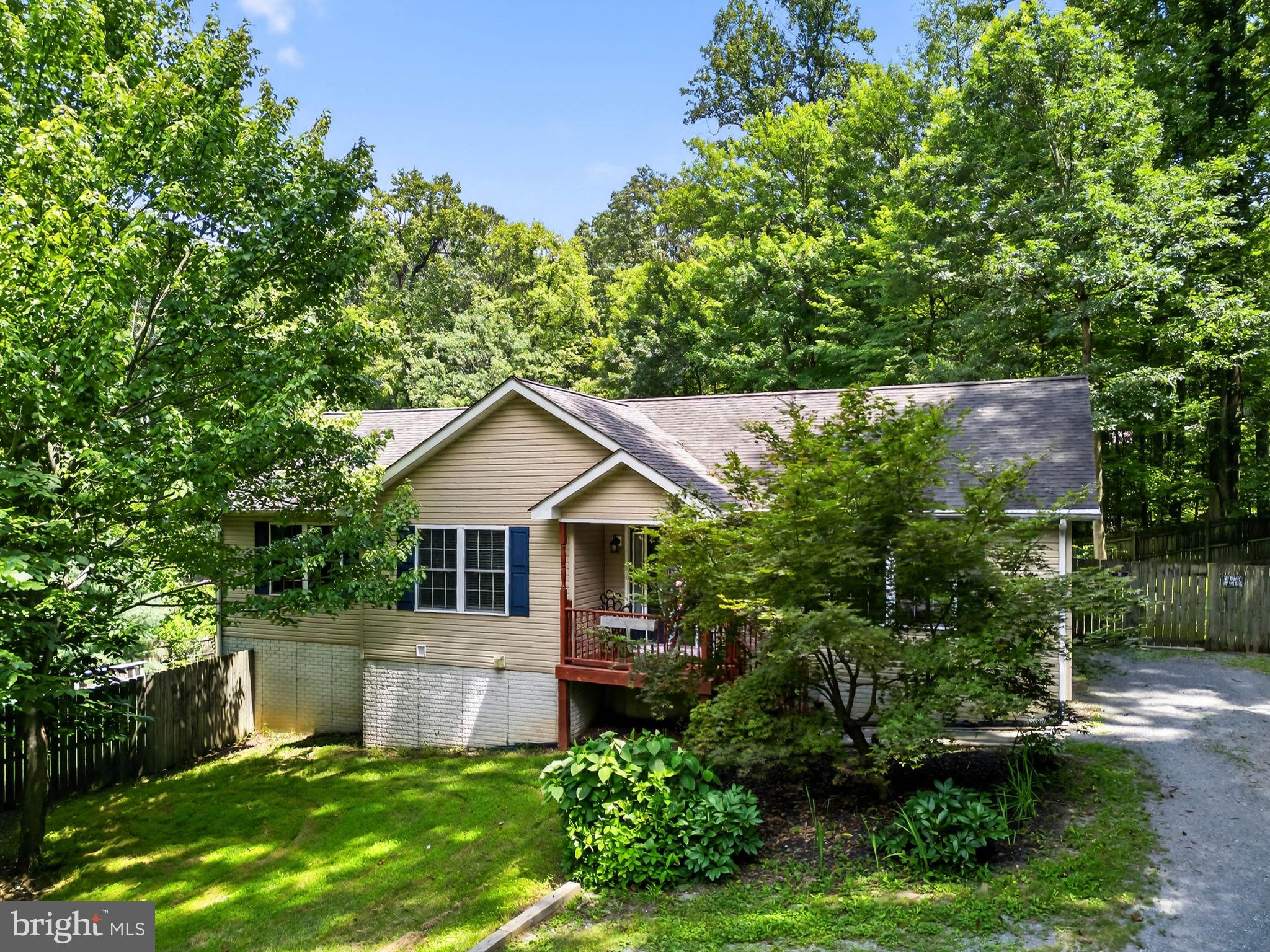 A Private Retreat with Room to Live, Grow, and Breathe.
If you’ve been craving a little more space, a little more peace, and a lot more connection with the outdoors, this 3-bedroom, 3-bath ranch-style home in the wooded Shannondale community of Harpers Ferry might just be your perfect match.
Set on a private lot surrounded by trees and wrapped in a tall wooden privacy fence, this move-in ready home has been lovingly cared for and offers a lifestyle that blends simplicity with possibility. Whether you’re tending the garden, collecting fresh eggs from your backyard chickens, or relaxing by the firepit under the stars, life feels a little fuller here.
Inside, the main level welcomes you with hardwood floors in the living room and an eat-in kitchen complete with stainless steel appliances, a double convection oven, and a refrigerator with ice maker. Down the hall are two bedrooms, a full bath, and a primary suite with an ensuite featuring a soaking tub and walk-in shower—your own quiet retreat at the end of the day.
The finished basement offers even more living space, featuring a large rec room with tile flooring, a pellet stove, a full bathroom with dual showerheads in the walk-in shower, a built-in desk, and access to the backyard through two French doors. You’ll also find a spacious laundry area with a folding station and utility sink, plus unfinished storage and pantry space to keep life organized.
The backyard is a true highlight—with room for chickens, rabbits, a vegetable garden, and even future pool plans. A side deck, picnic area, and hammock posts make it easy to enjoy every square foot.
Located within reach of Harpers Ferry National Historical Park, Lake Shannondale, and miles of trails, this home is ideal for anyone looking to enjoy the natural beauty and calm that comes with mountain living—all while staying close to schools, commuter routes, and local conveniences. A brand-new HVAC system installed July 2025 for added peace of mind.
Come see how this one-of-a-kind property combines privacy, comfort, and the freedom to live your way. Schedule your tour today.